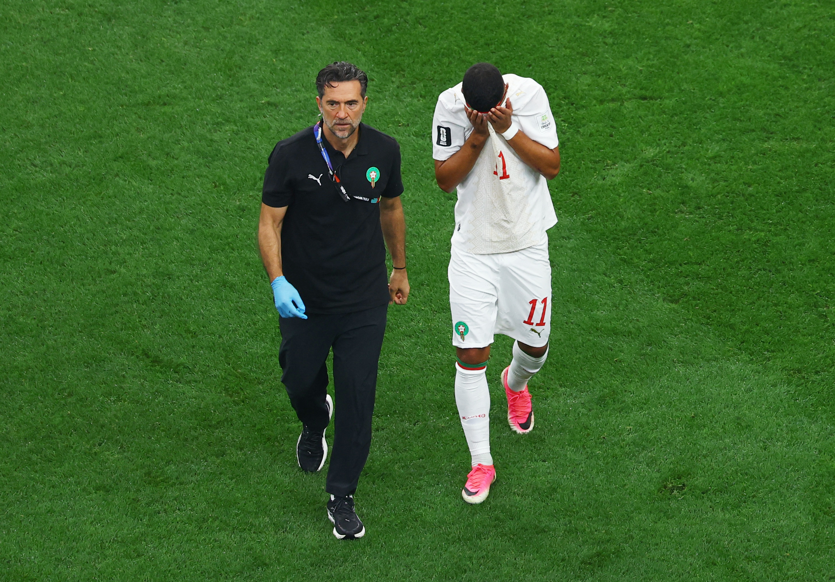 Morocco's Ismael Saibari comes off the pitch to receive medical attention after sustaining an injury