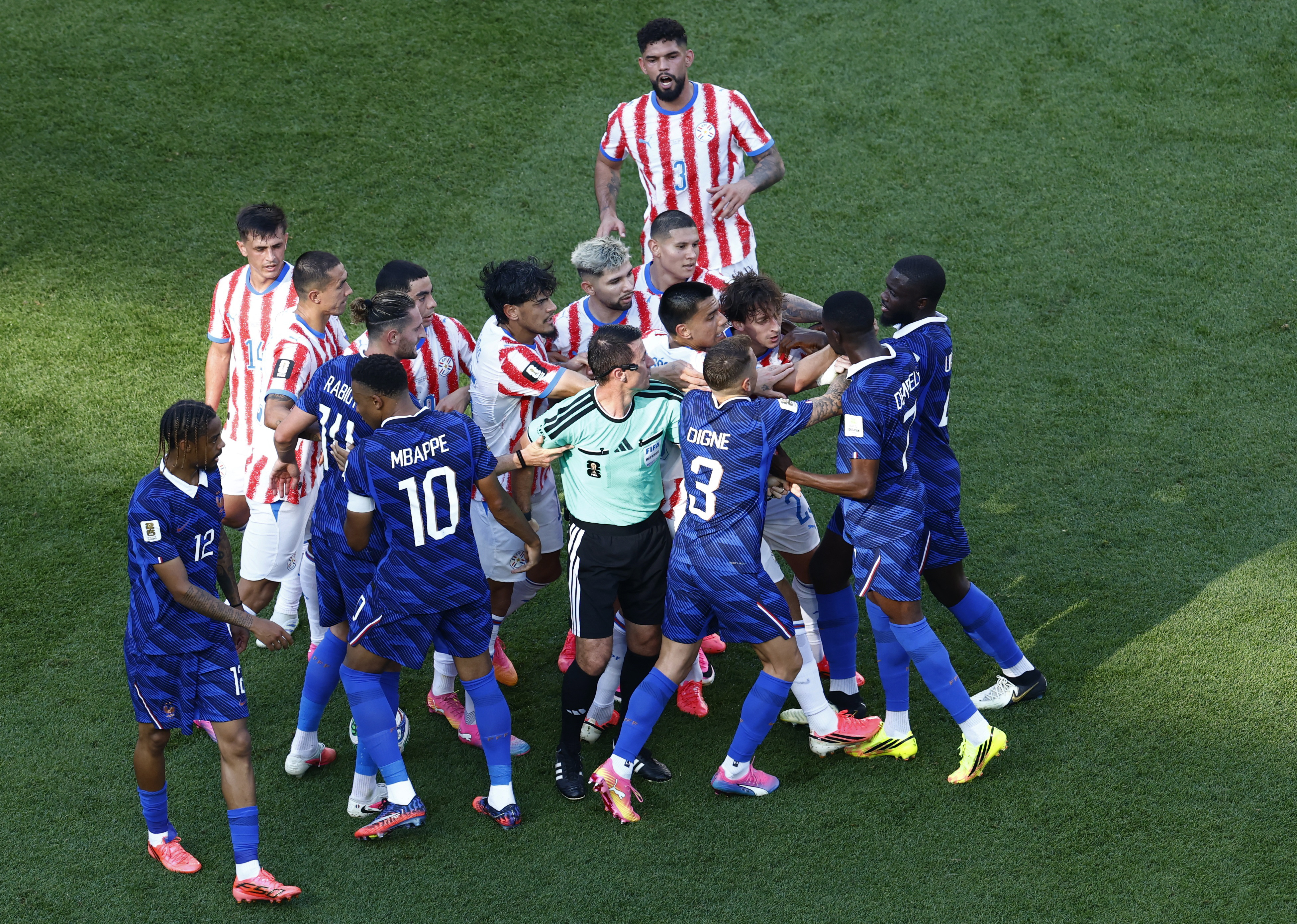 France's Ousmane Dembele clashes with Paraguay players after Andres Cubas fouls Kylian Mbappe