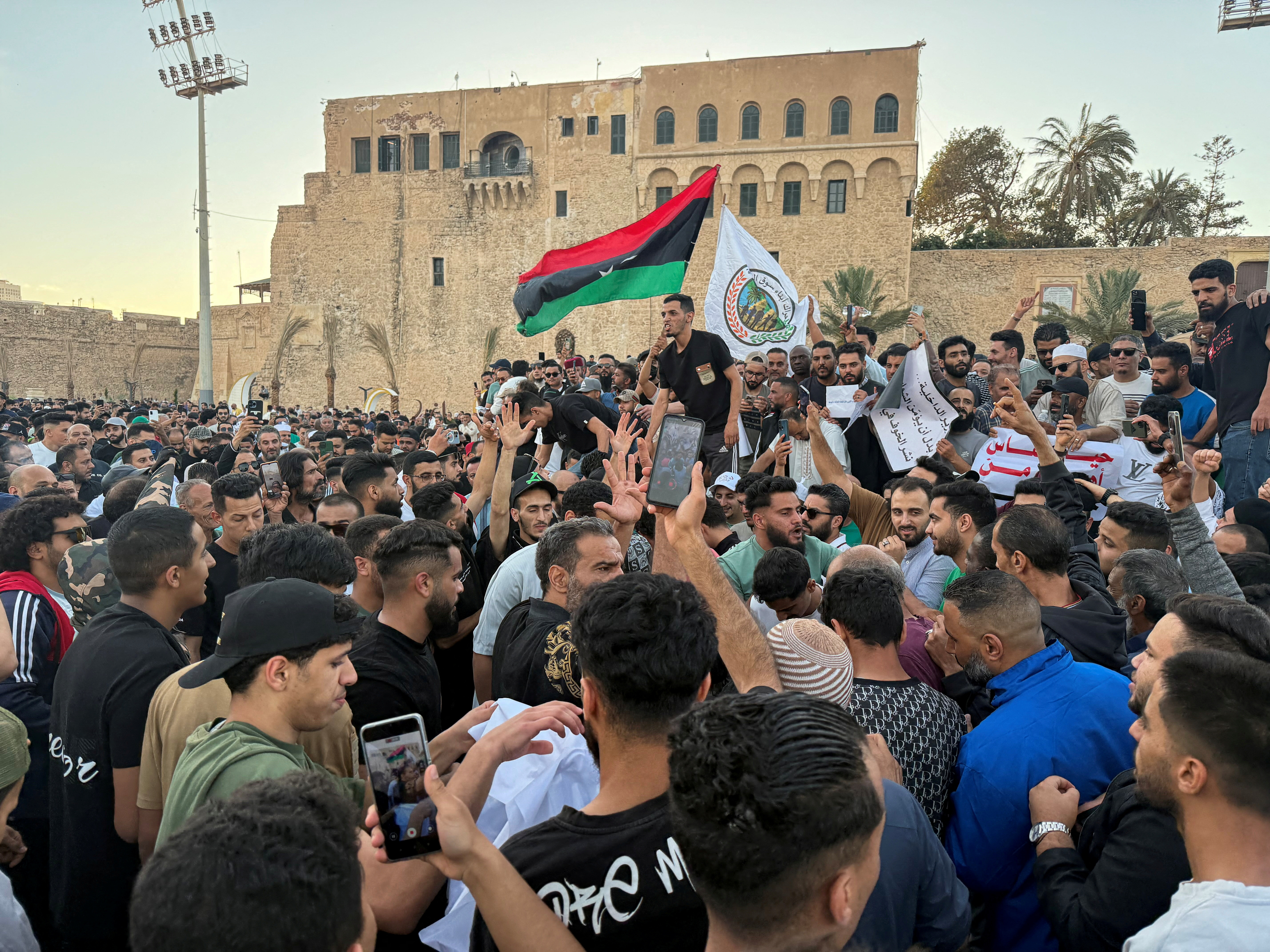Demonstrators with a Libyan and other flags.