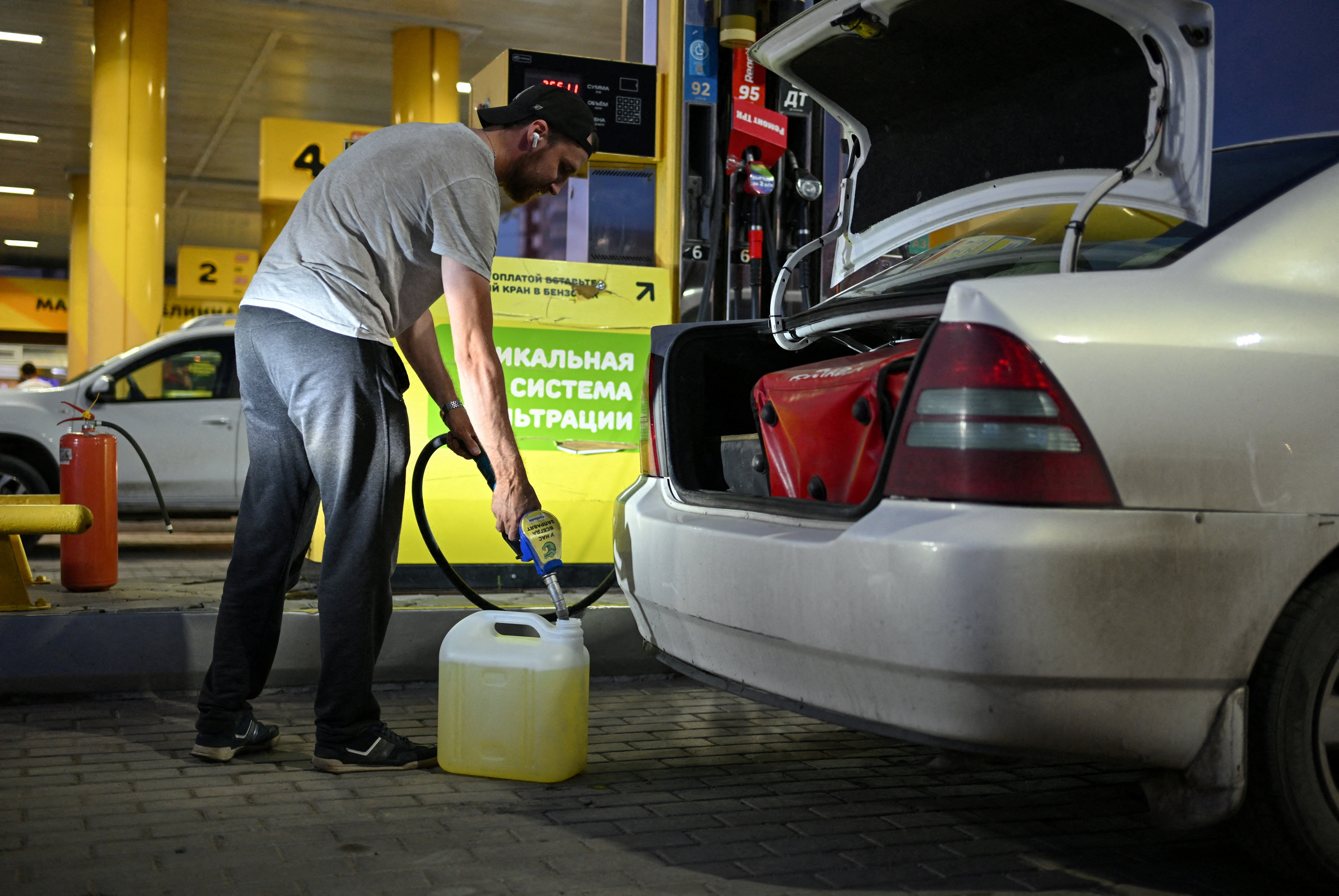 A man fills a fuel canister at a gasoline pump in the Siberian city of Omsk, Russia, July 6, 2026. REUTERS/Alexey Malgavko TPX IMAGES OF THE DAY