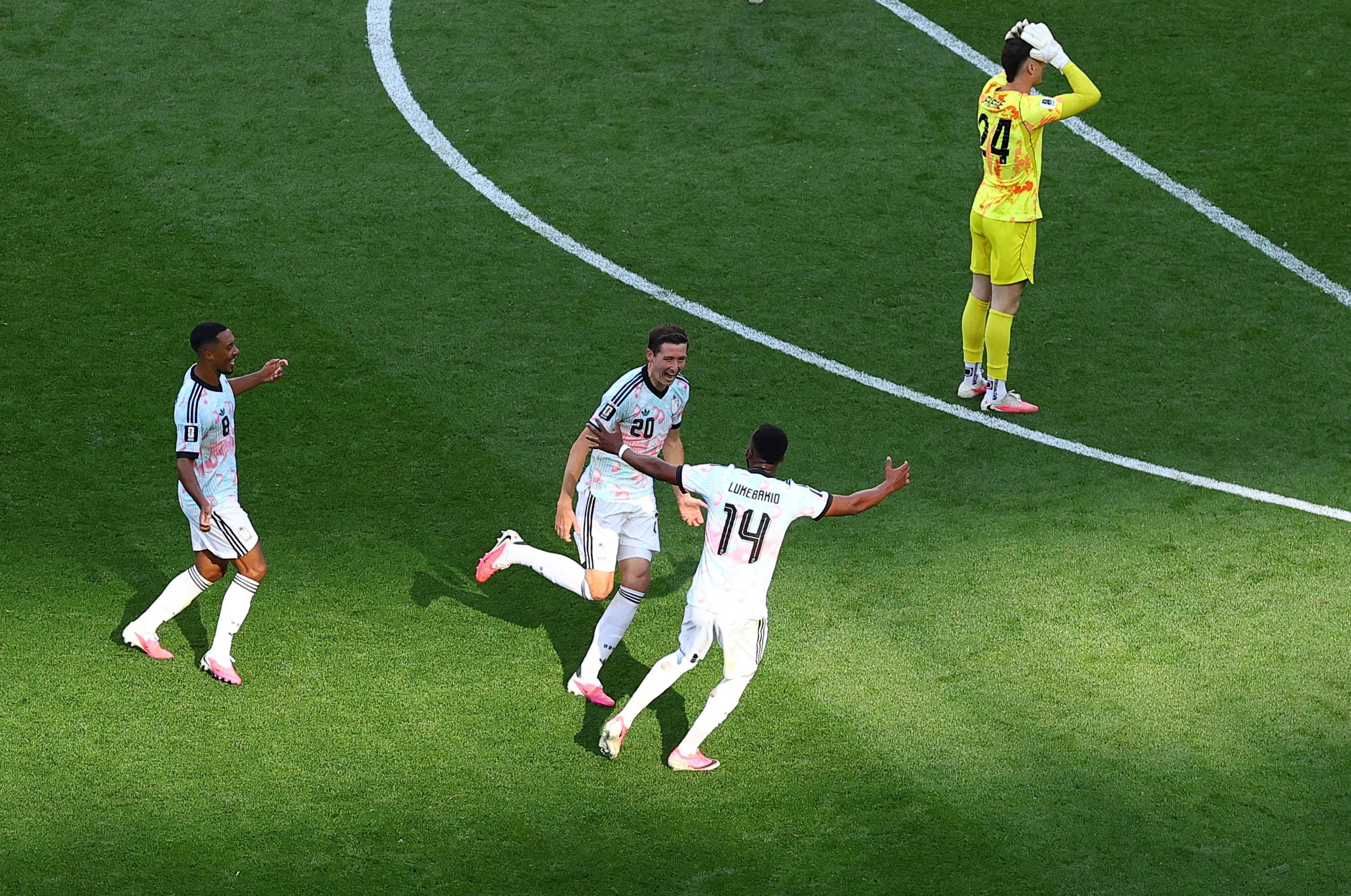 Belgium's Hans Vanaken celebrates scoring their third goal with Dodi Lukebakio and Youri Tielemans as Matt Freese of the U.S. reacts