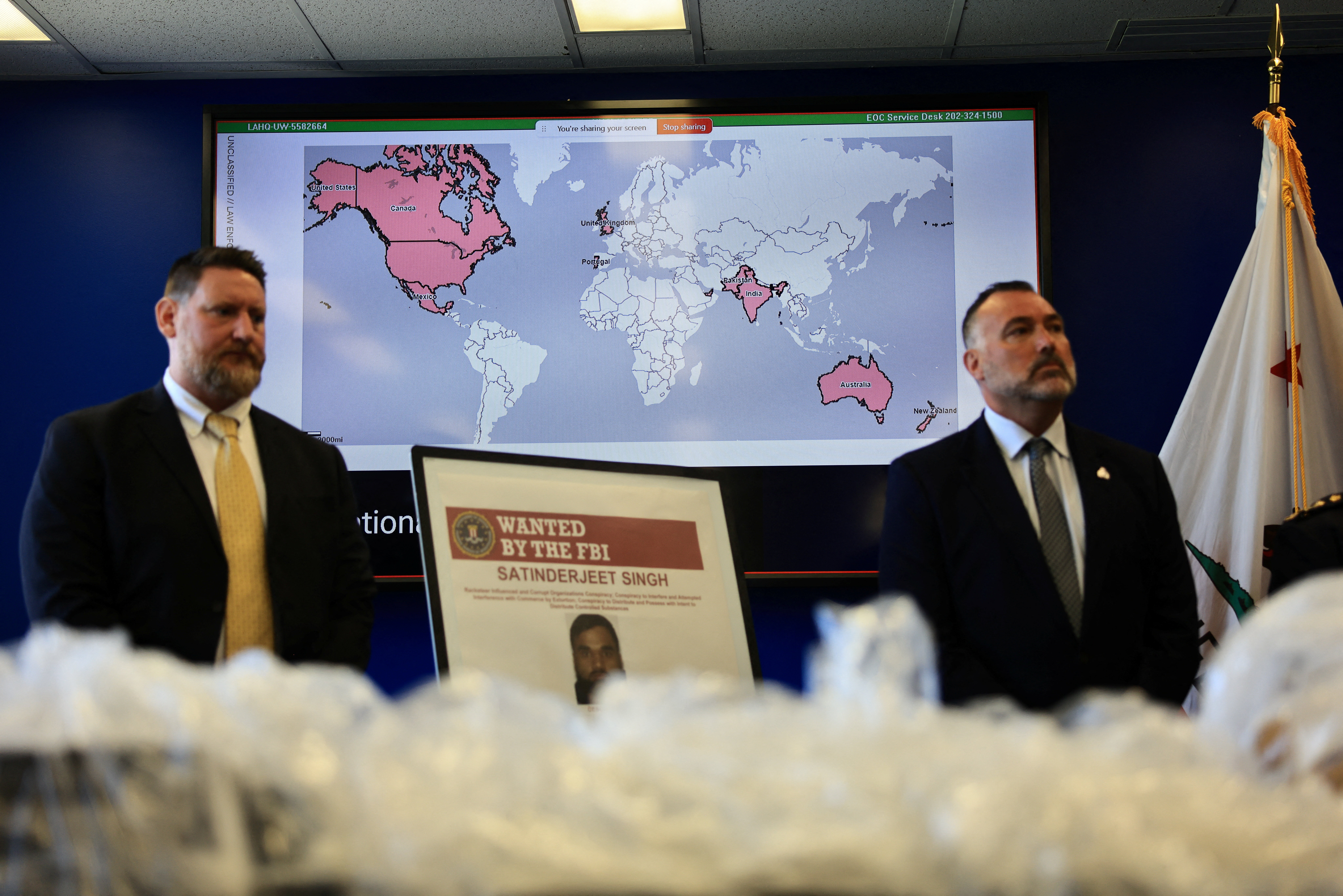 A screen displays a map, as U.S. and Canadian law enforcement officials announce federal charges and arrests of alleged members of a transnational organized crime group, at FBI offices in Los Angeles, California, U.S. July 7, 2026. REUTERS/David Swanson