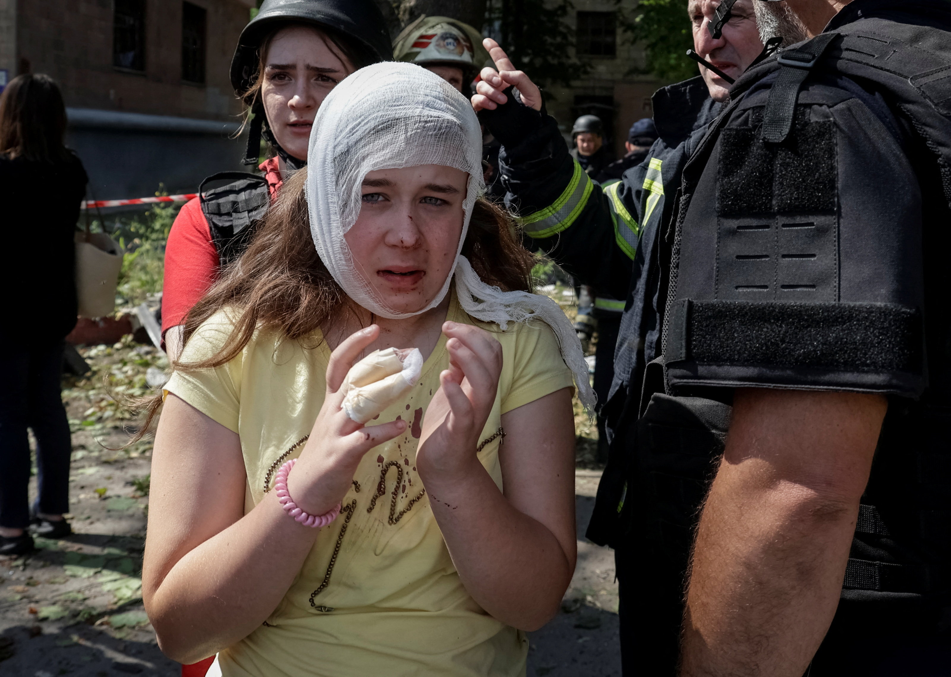 SENSITIVE MATERIAL. THIS IMAGE MAY OFFEND OR DISTURB A medical worker assists a wounded resident at a site of an apartment building hit by a Russian missile strike, amid Russia's attack on Ukraine, in Kharkiv, Ukraine July 8, 2026. REUTERS/Sofiia Gatilova TPX IMAGES OF THE DAY
