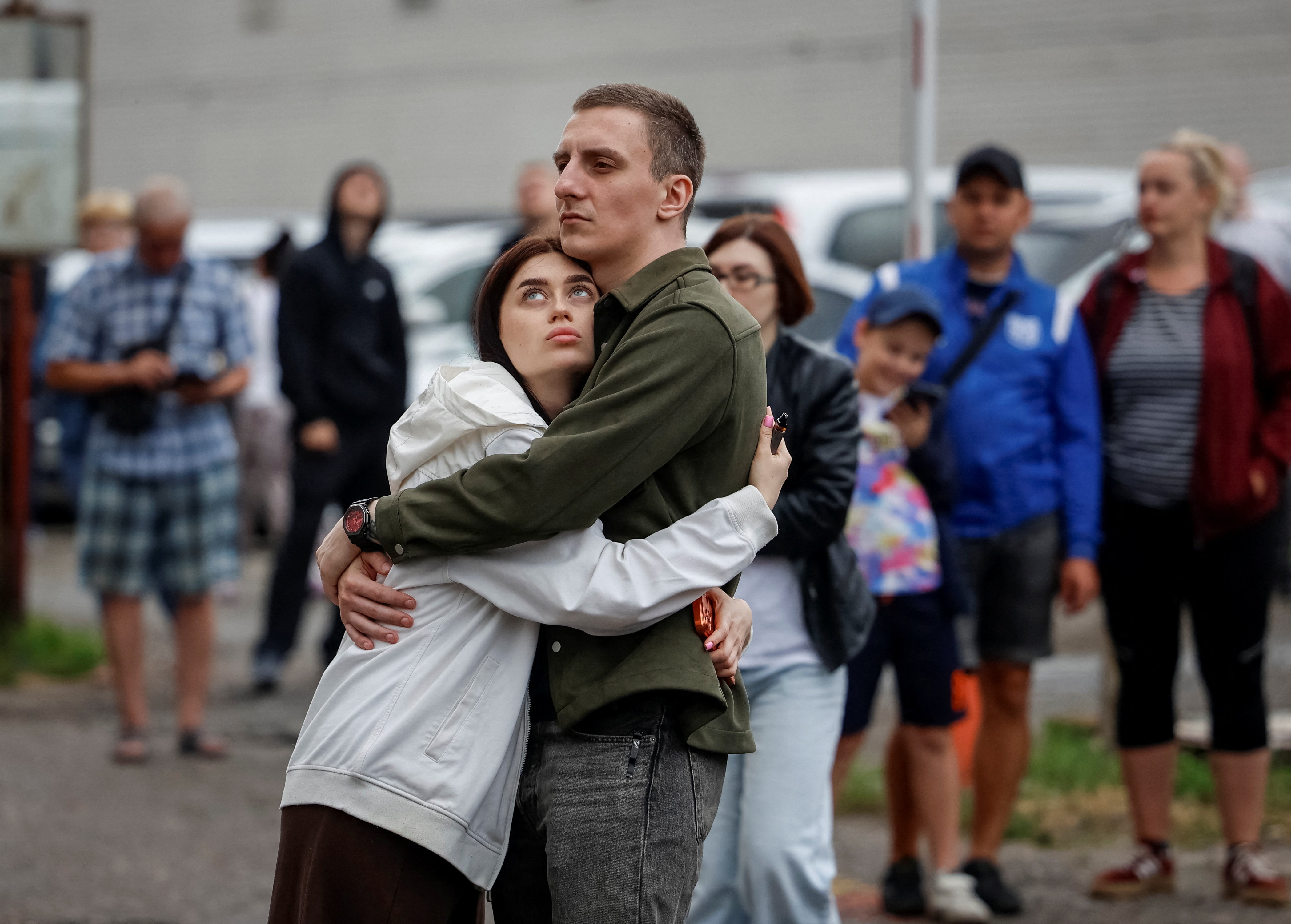 Residents stand near an apartment building hit by a Russian drone strike, amid Russia's attack on Ukraine, in Kyiv, Ukraine July 8, 2026. REUTERS/Stringer TPX IMAGES OF THE DAY
