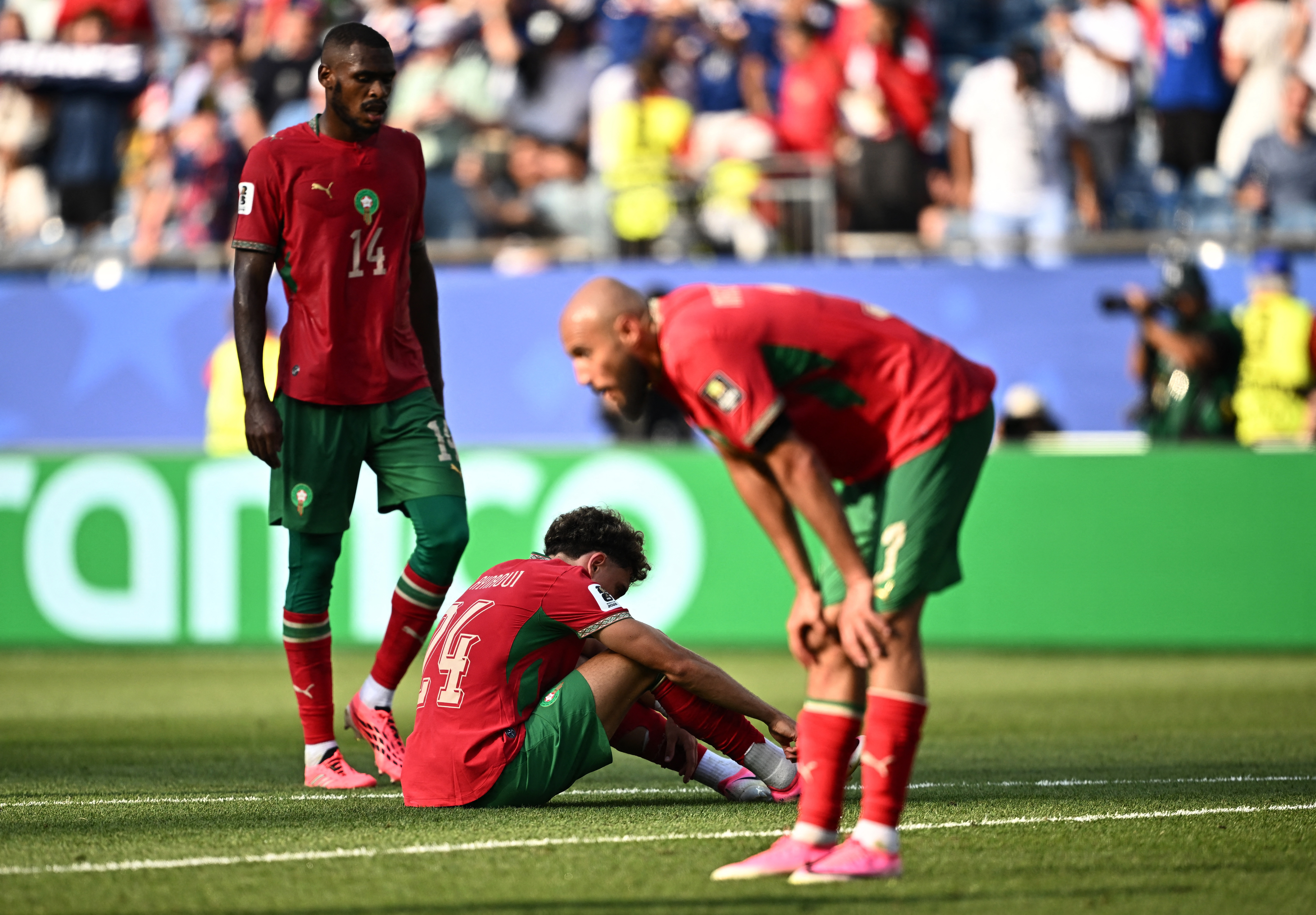 Morocco's Noussair Mazraoui, Issa Diop and Neil El Aynaoui look dejected after the france match as Morocco are eliminated from the World Cup