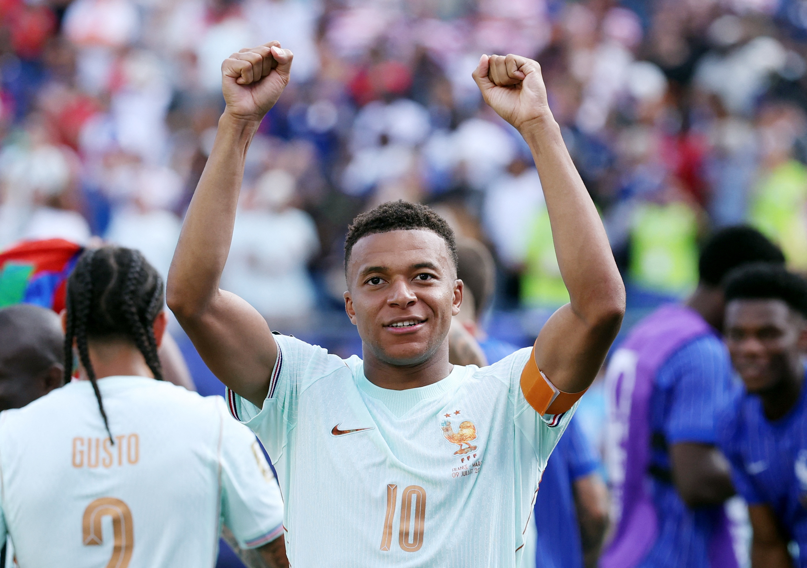 Mbappe raises his arms in celebration