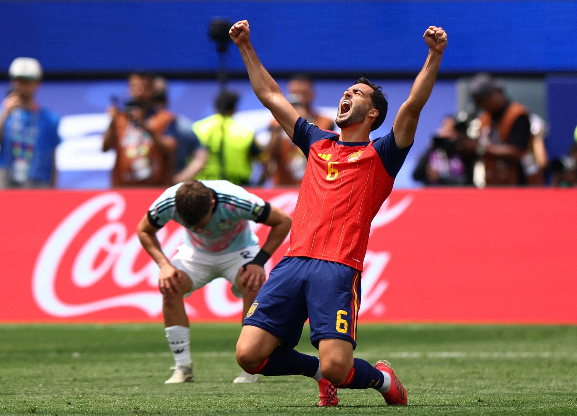Spain’s Mikel Merino celebrates the victory against Belgium