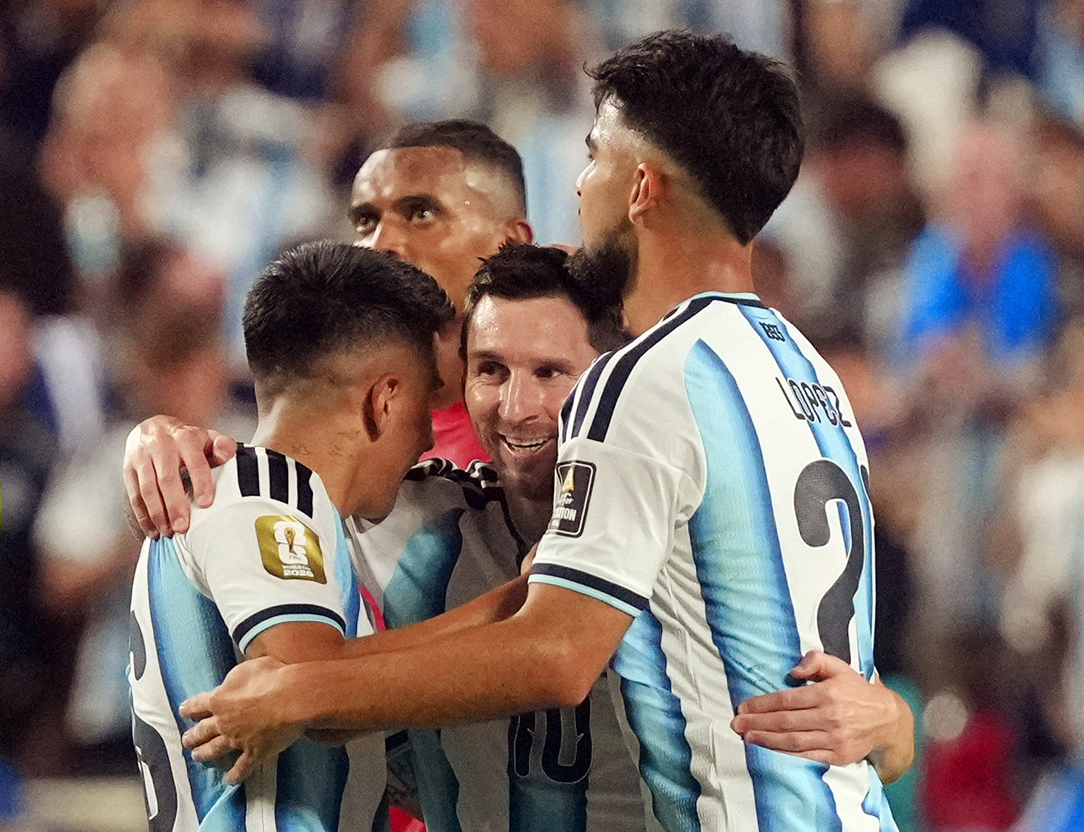 Argentina's Lionel Messi celebrates after the match with Jose Manuel Lopez