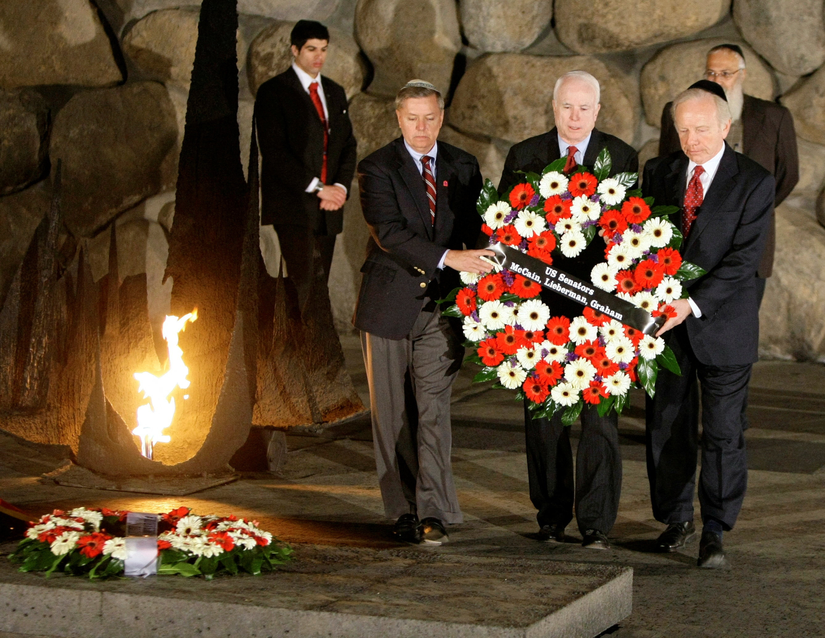 FILE PHOTO: (From R to L) U.S. Senator Joe Lieberman (I-CT), U.S. Republican presidential candidate Senator John McCain (R-AZ) and U.S. Senator Lindsey Graham (R-SC) lay a wreath together during a memorial ceremony at Yad Vashem Holocaust Memorial in Jerusalem March 18, 2008. REUTERS/Peter Andrews/File Photo