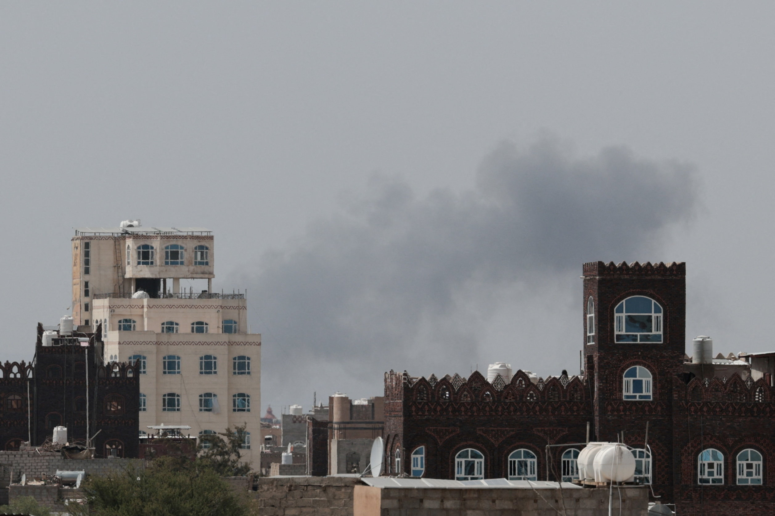 Smoke rises after reports of an air strike near the Sanaa international airport, Yemen