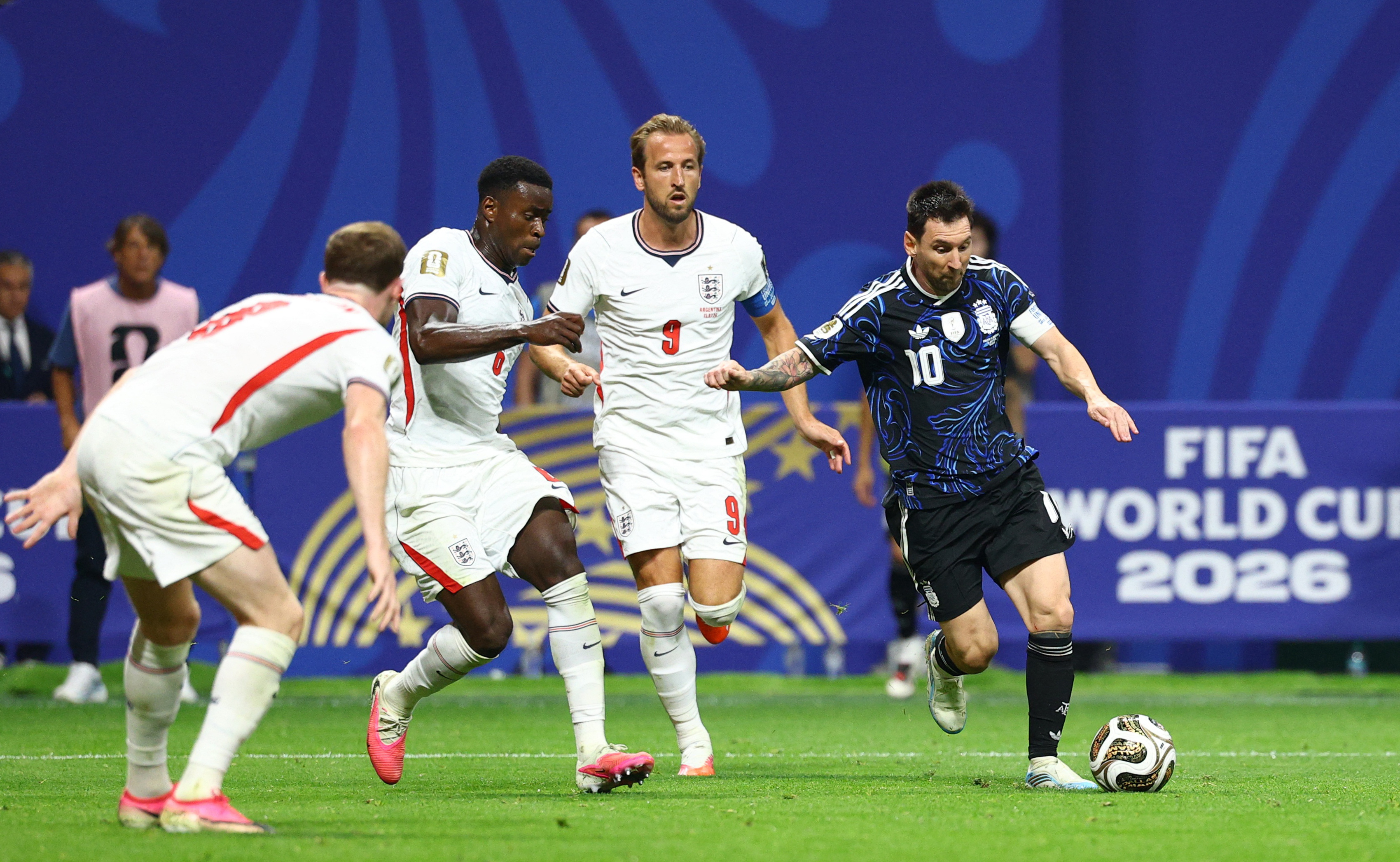 Argentina's Lionel Messi in action with England's Marc Guehi and Harry Kane