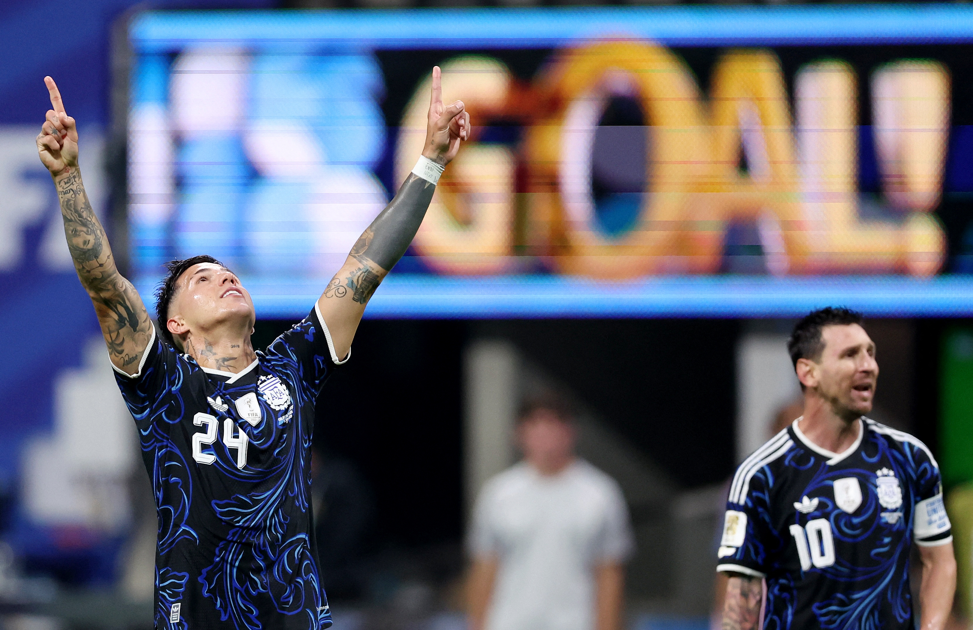 Argentina's Enzo Fernandez celebrates with Lionel Messi.