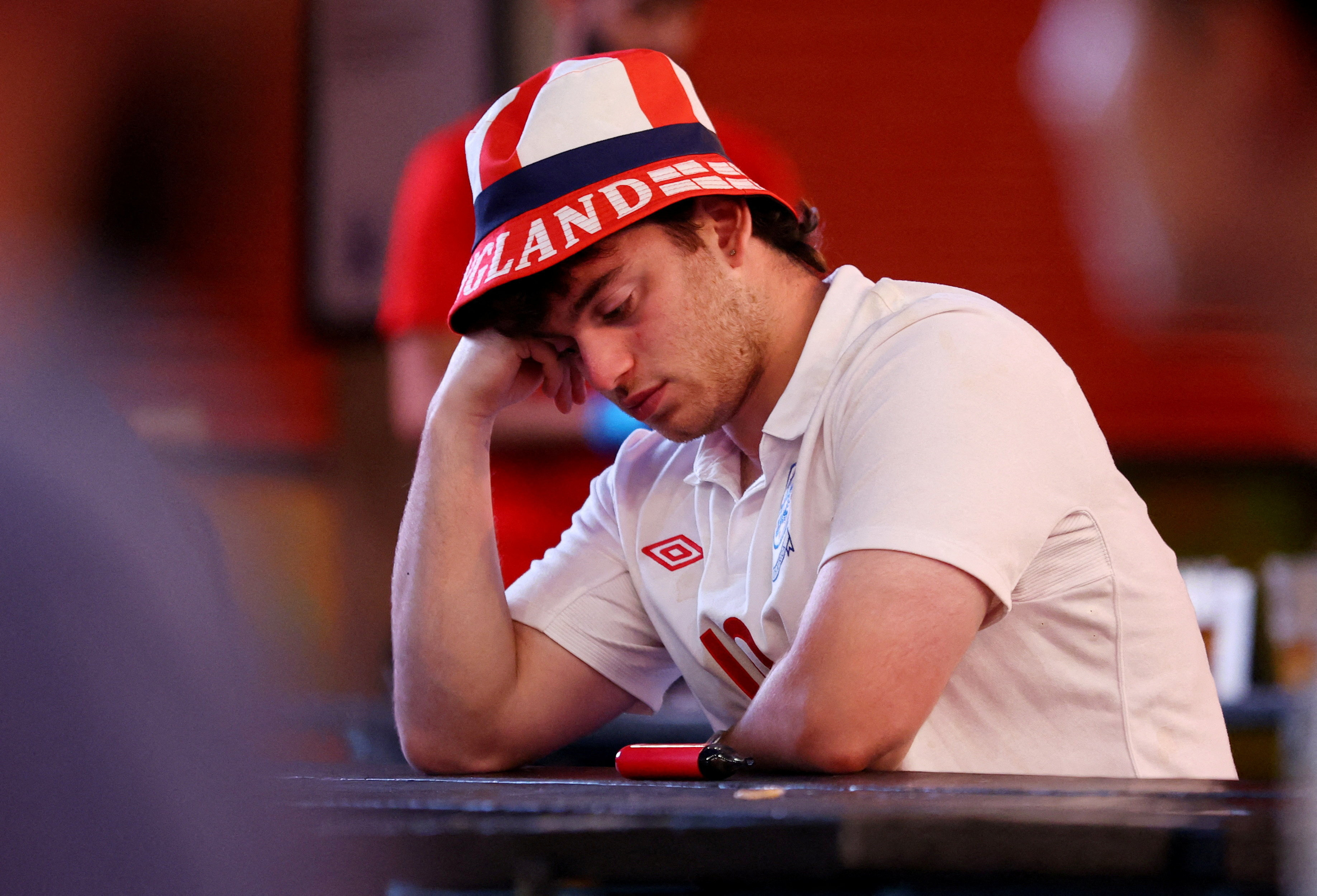 Soccer Football - FIFA World Cup 2026 - Semi Final - England v Argentina - Fans gather in Manchester - 4TheFans Fan Park, Freight Island, Manchester, Britain - - July 15, 2026 England fan looks dejected after the match as England are eliminated from the World Cup REUTERS/Ed Sykes TPX IMAGES OF THE DAY