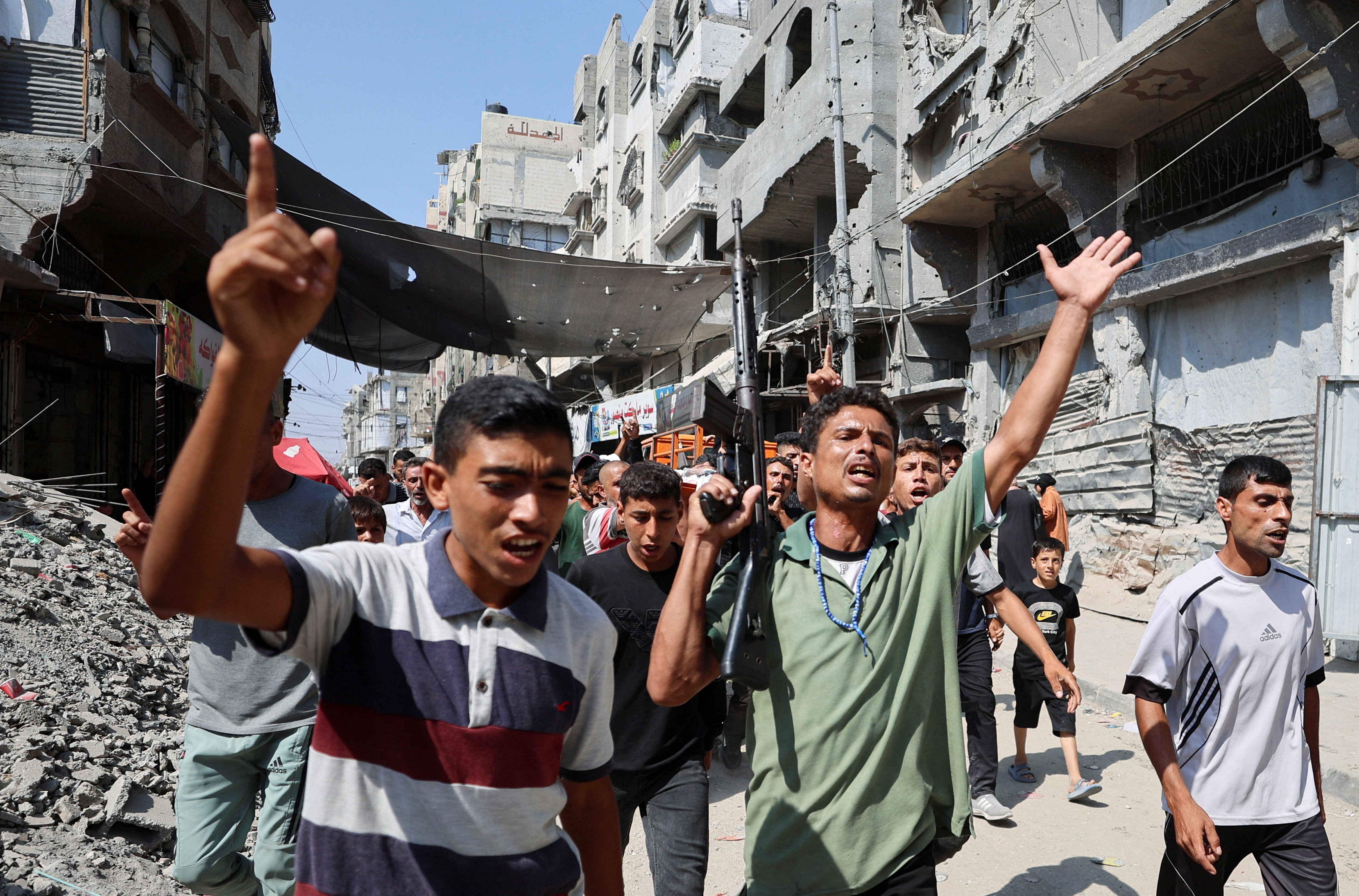 SENSITIVE MATERIAL. THIS IMAGE MAY OFFEND OR DISTURB Mourners react while carrying a body during the funeral of three Palestinians, who were killed in an Israeli strike, according to medics, in Gaza City, July 16, 2026. REUTERS/Dawoud Abu Alkas