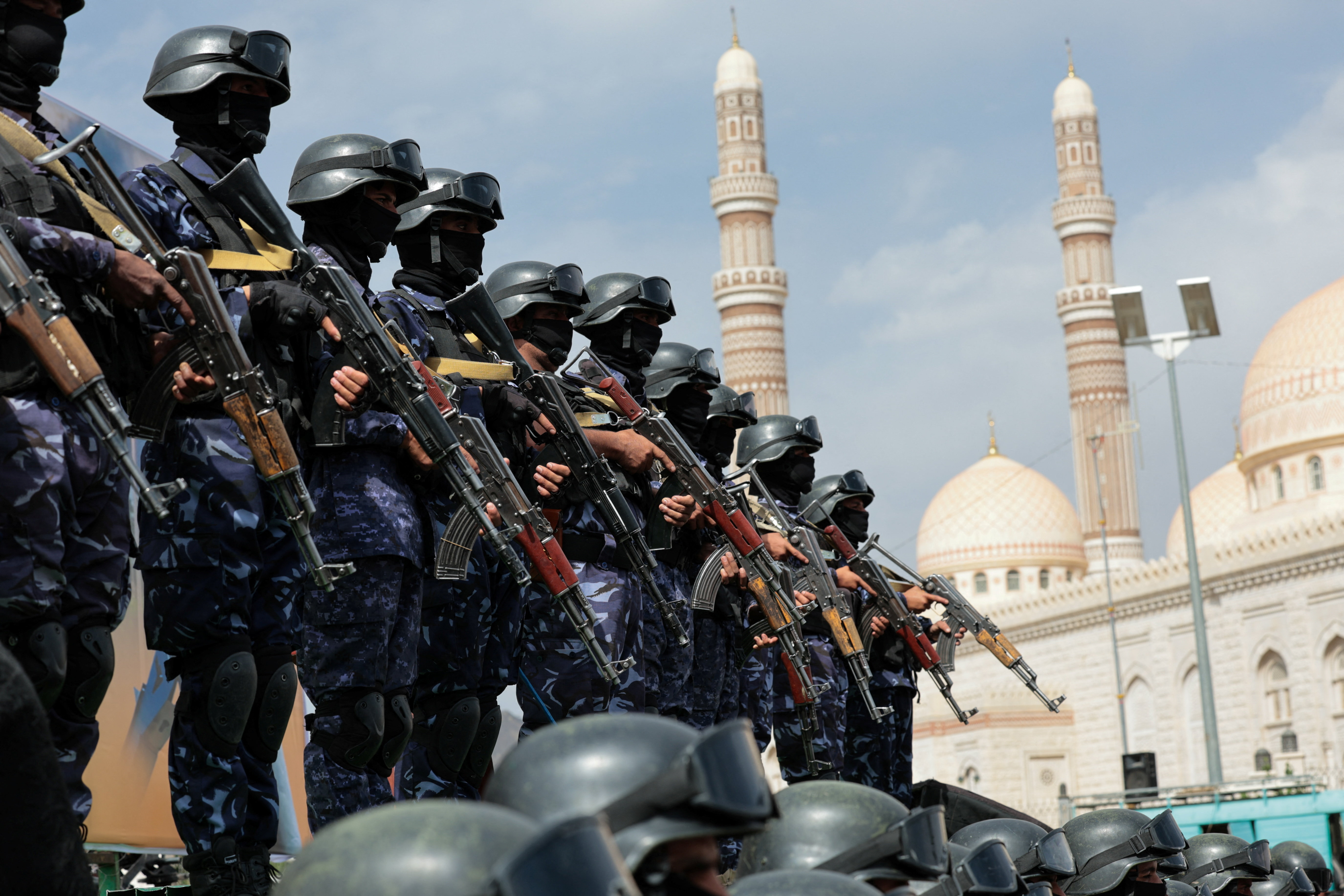 Houthi security force personnel stand guard in the Yemeni capital Sanaa as Houthi supporters rally against the Saudi-led coalition’s restrictions on Houthi-controlled areas, which the group describes as a blockade, July 17, 2026
