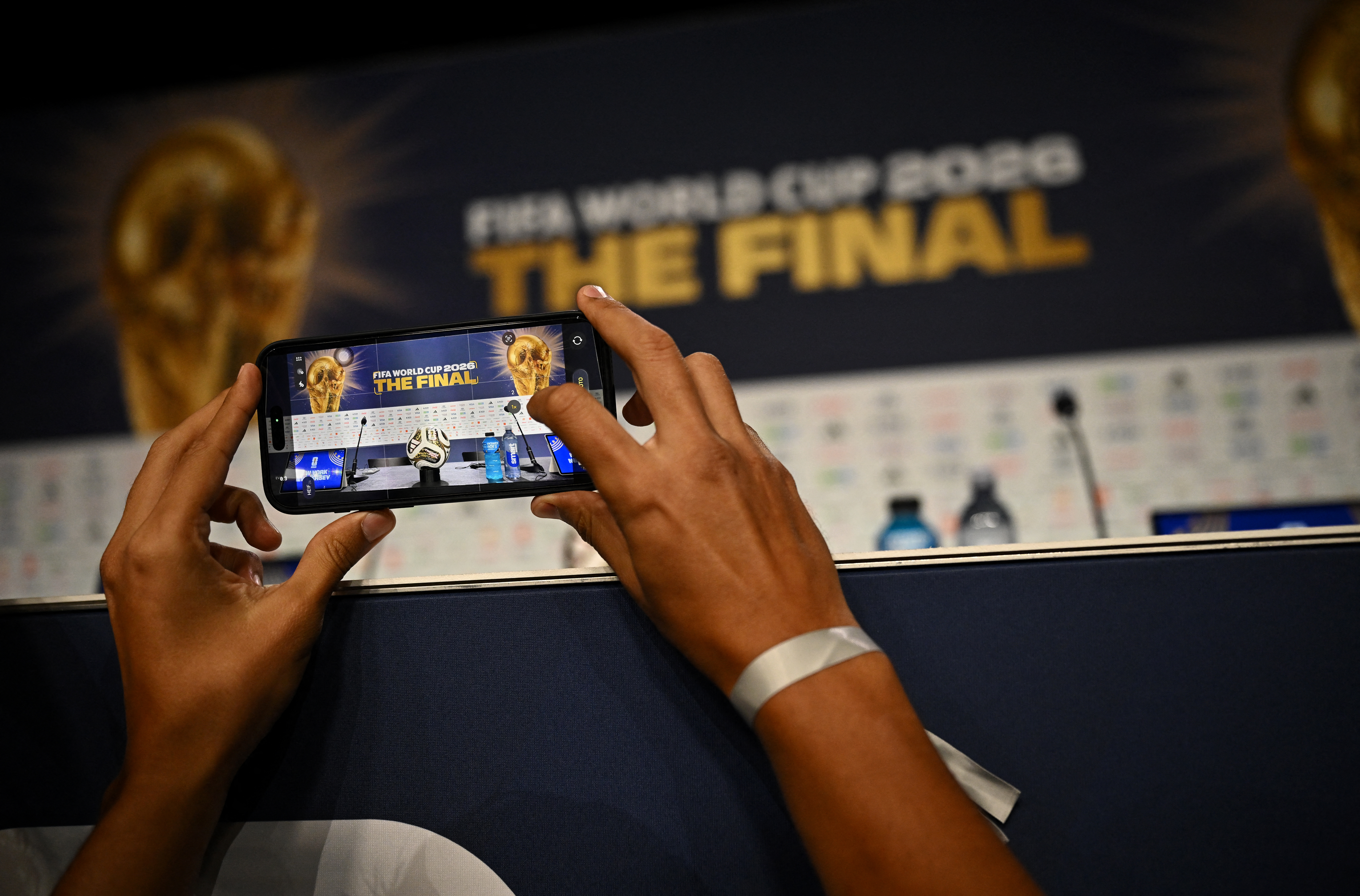 Soccer Football - FIFA World Cup 2026 - Spain Press Conference - Javits Center, New York City, New York, U.S. - July 17, 2026 A journalist takes a picture of the new adidas Trionda Final ball, the official match ball for the final of the FIFA World Cup before the press conference REUTERS/Dylan Martinez