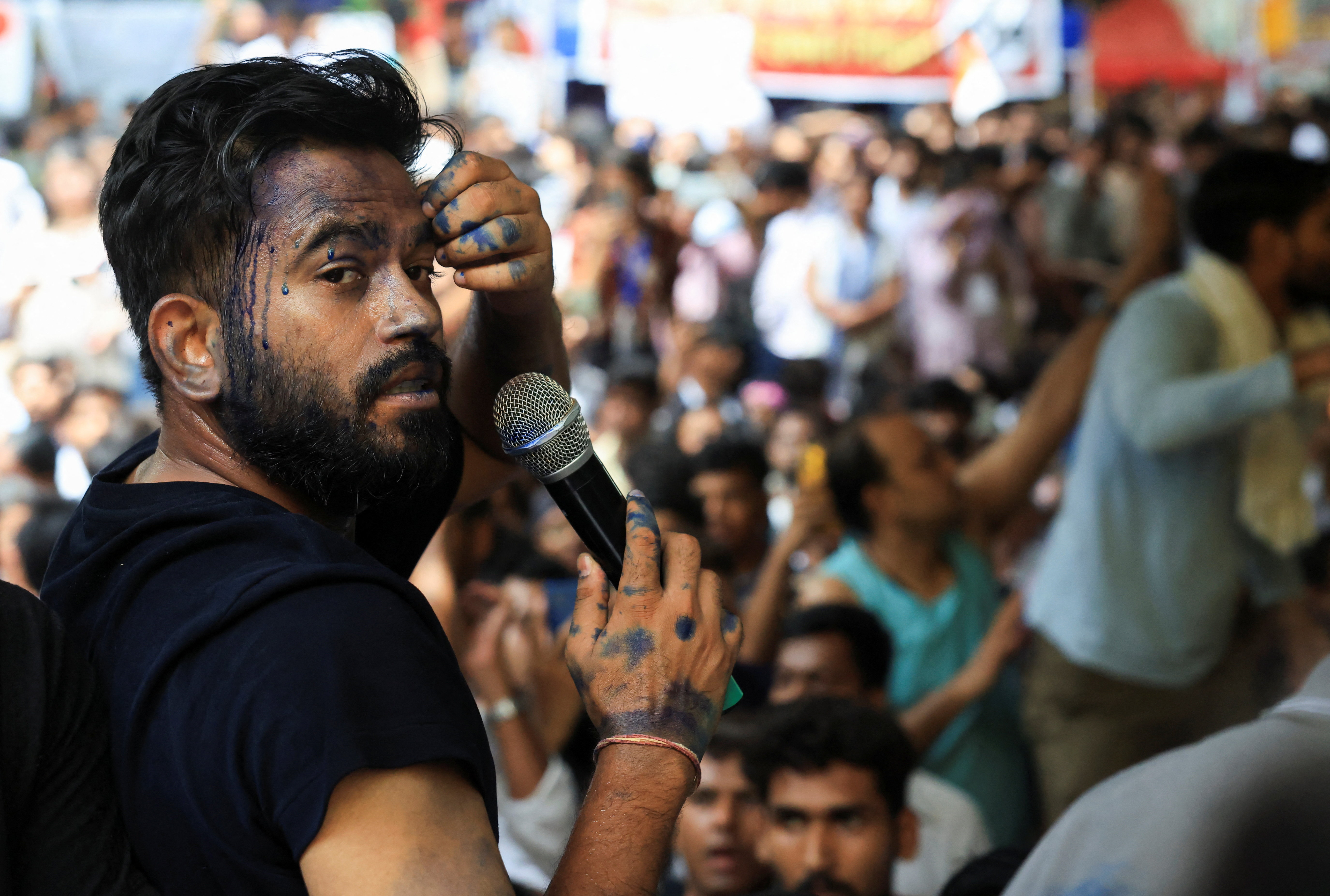 Abhijeet Dipke, founder of the Cockroach Janta Party, after a woman threw blue ink-like liquid on him after he began his hunger strike at Jantar Mantar, New Delhi, India, on July 18, 2026