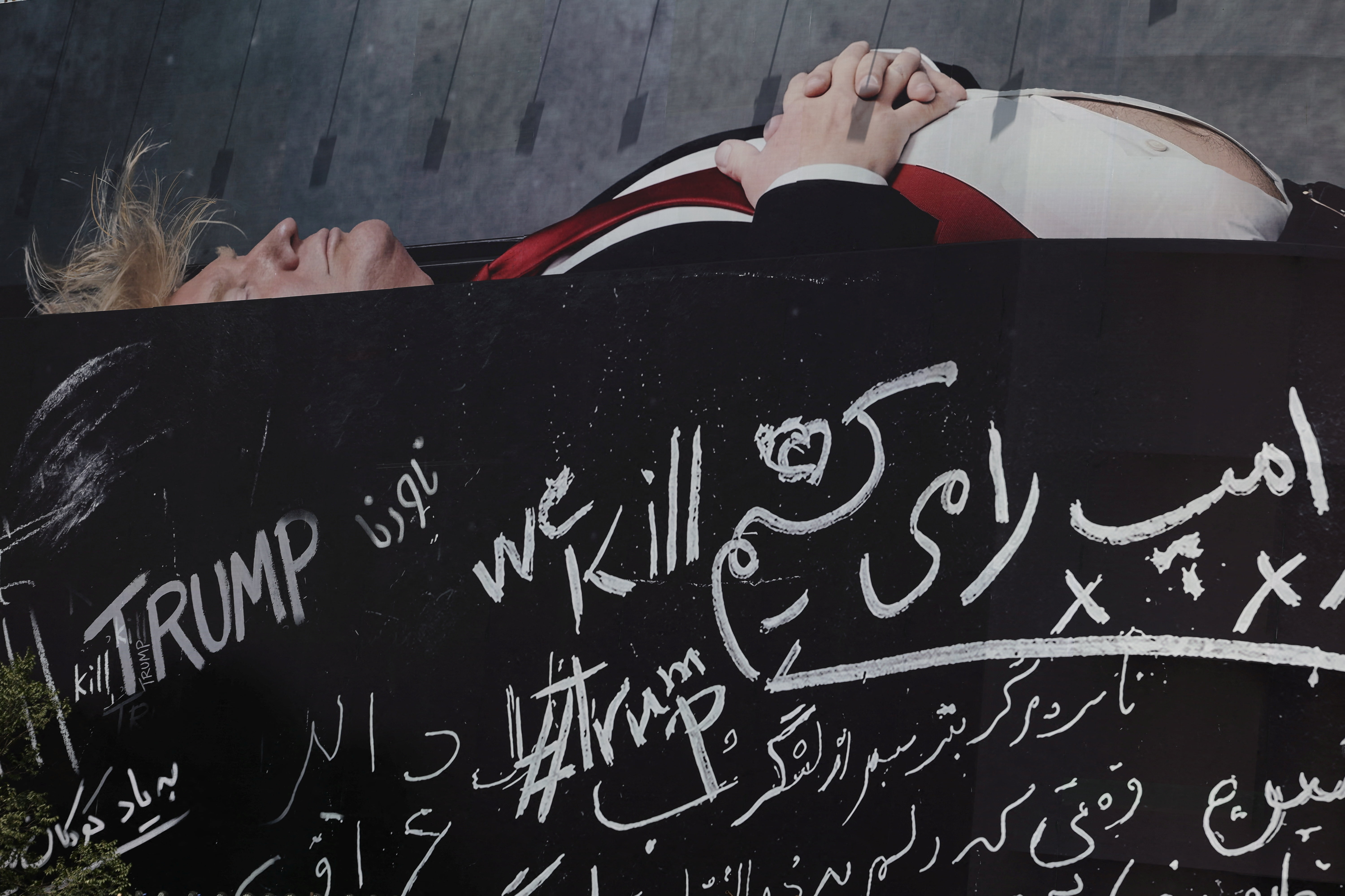A billboard depicting US President Donald Trump lying in a coffin on a building in Tehran, Iran, July 18, 2026