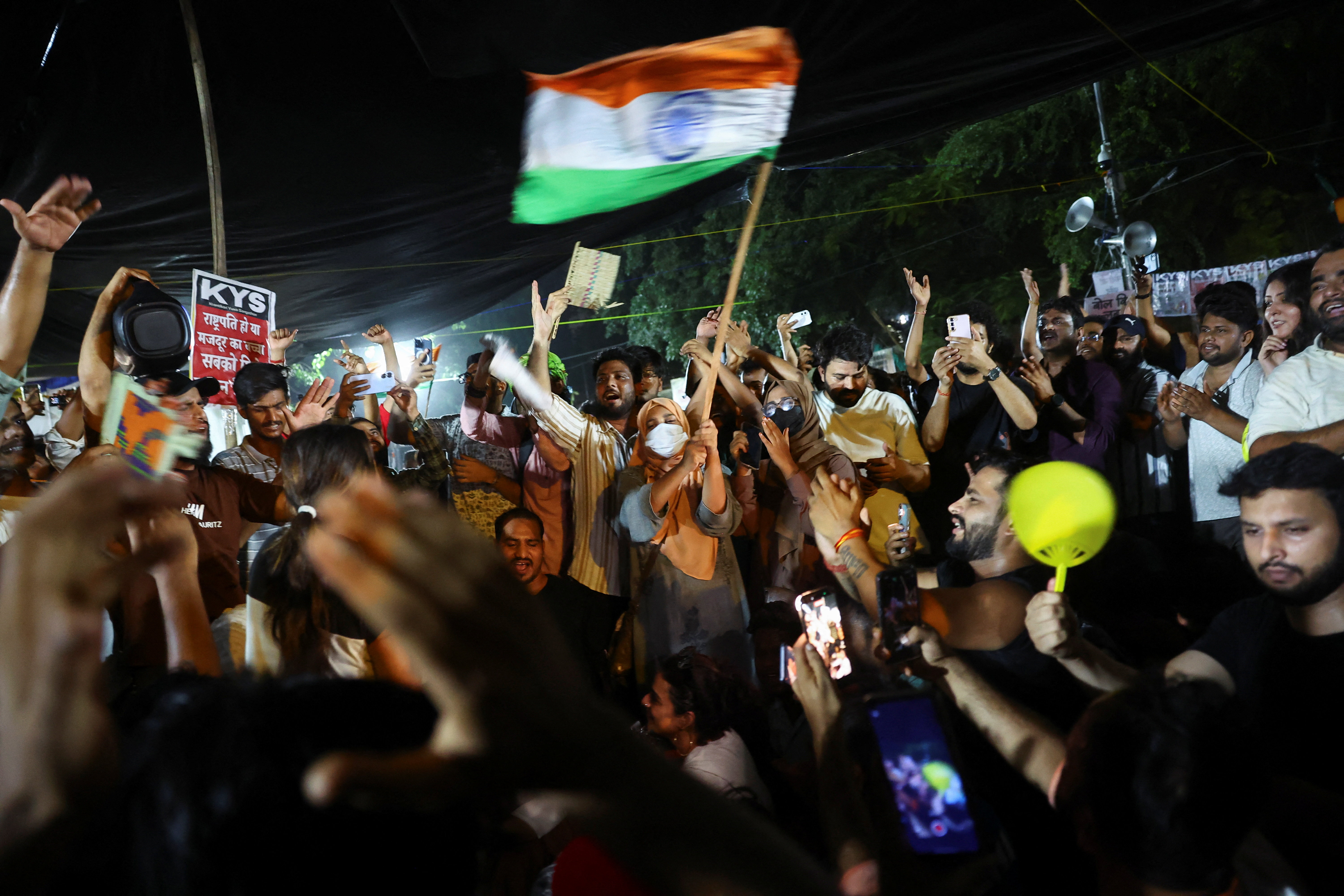 Protesters wave the Indian flag after Sonam Wangchuk was forcibly taken to hospital at Jantar Mantar, New Delhi, India, on July 19, 2026