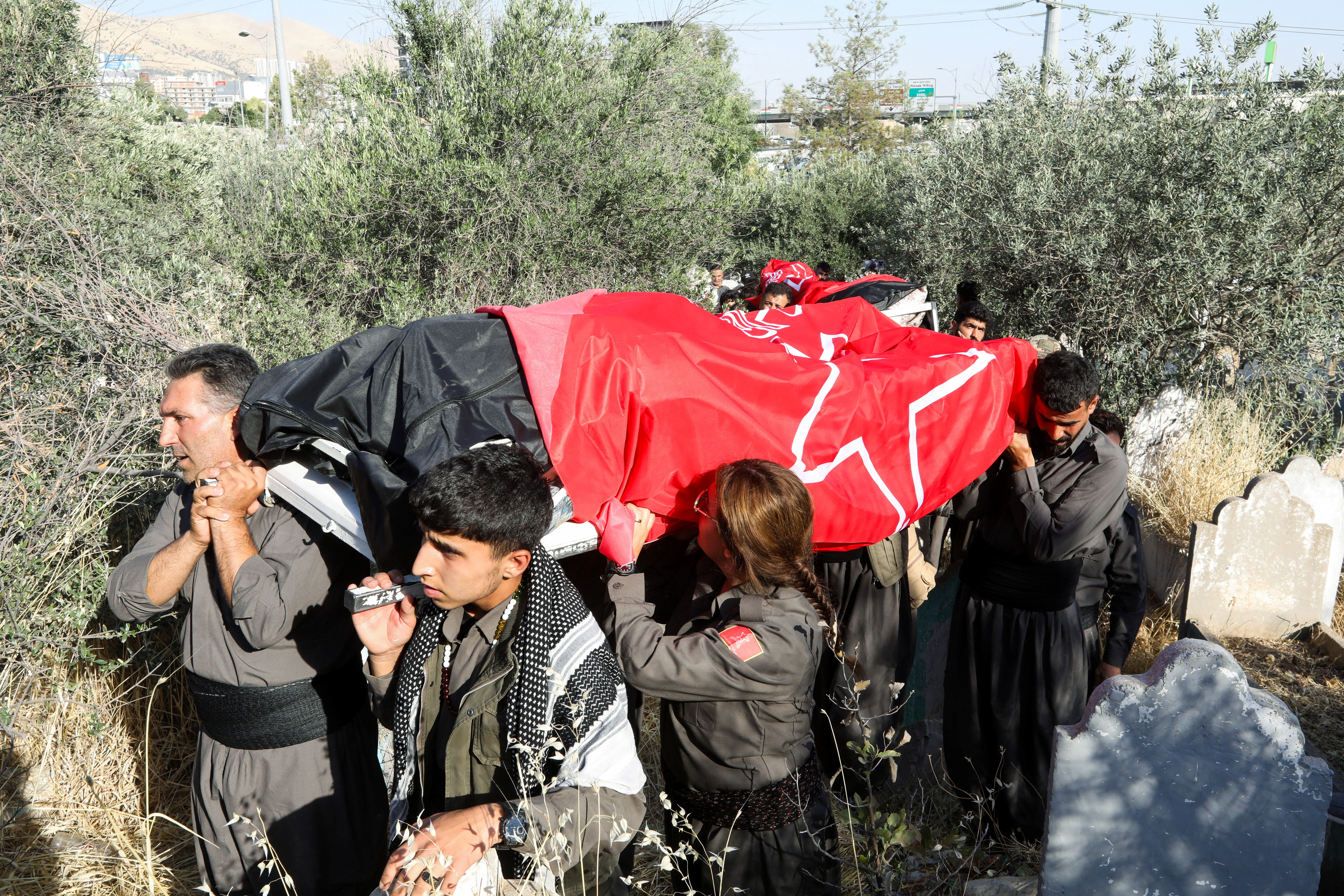 People attend a funeral procession for members of the Iranian Kurdish opposition group Komala who were killed in a missile strike on the group's headquarters, in Sulaymaniyah, Iraq