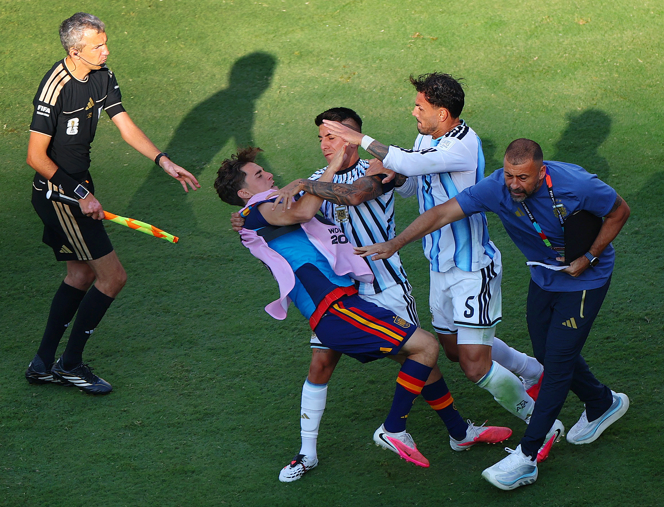 Argentina's Leandro Paredes and Thiago Almada clash with Spain's Gavi after the match