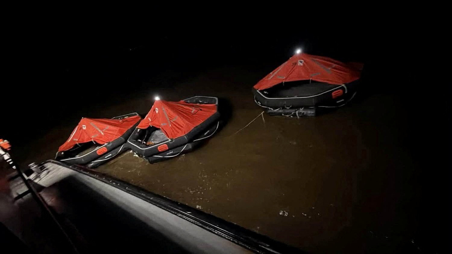 Lifeboats float on the water during search and rescue efforts after a ferry carrying passengers sank off the coast of Guyana in South America, in this handout image released on July 19, 2026.