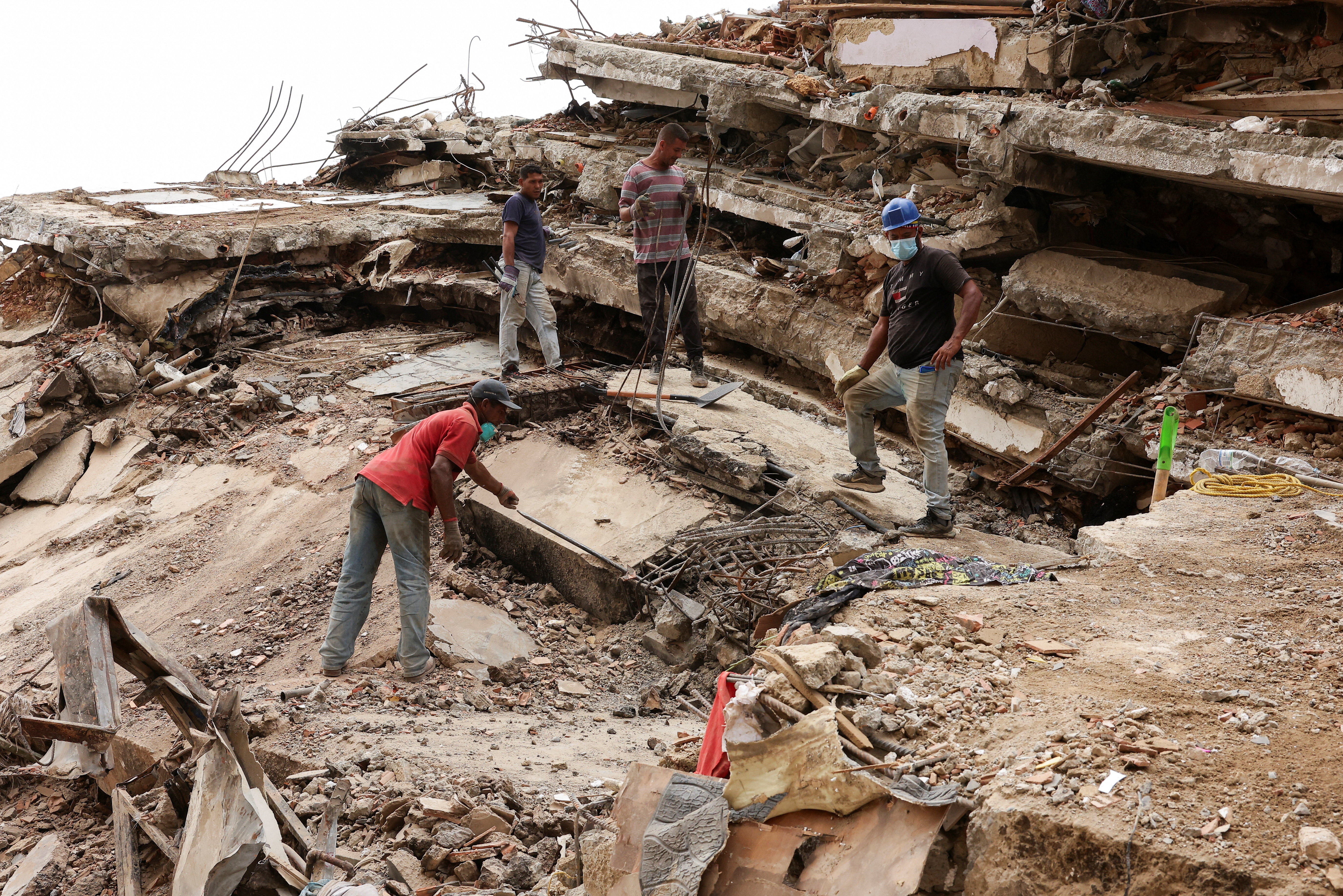 People work together as they search for their loved ones amid debris, in the aftermath of the June 24 earthquakes, at Caraballeda, in La Guaira, Venezuela, July 19, 2026. REUTERS/Gaby Oraa