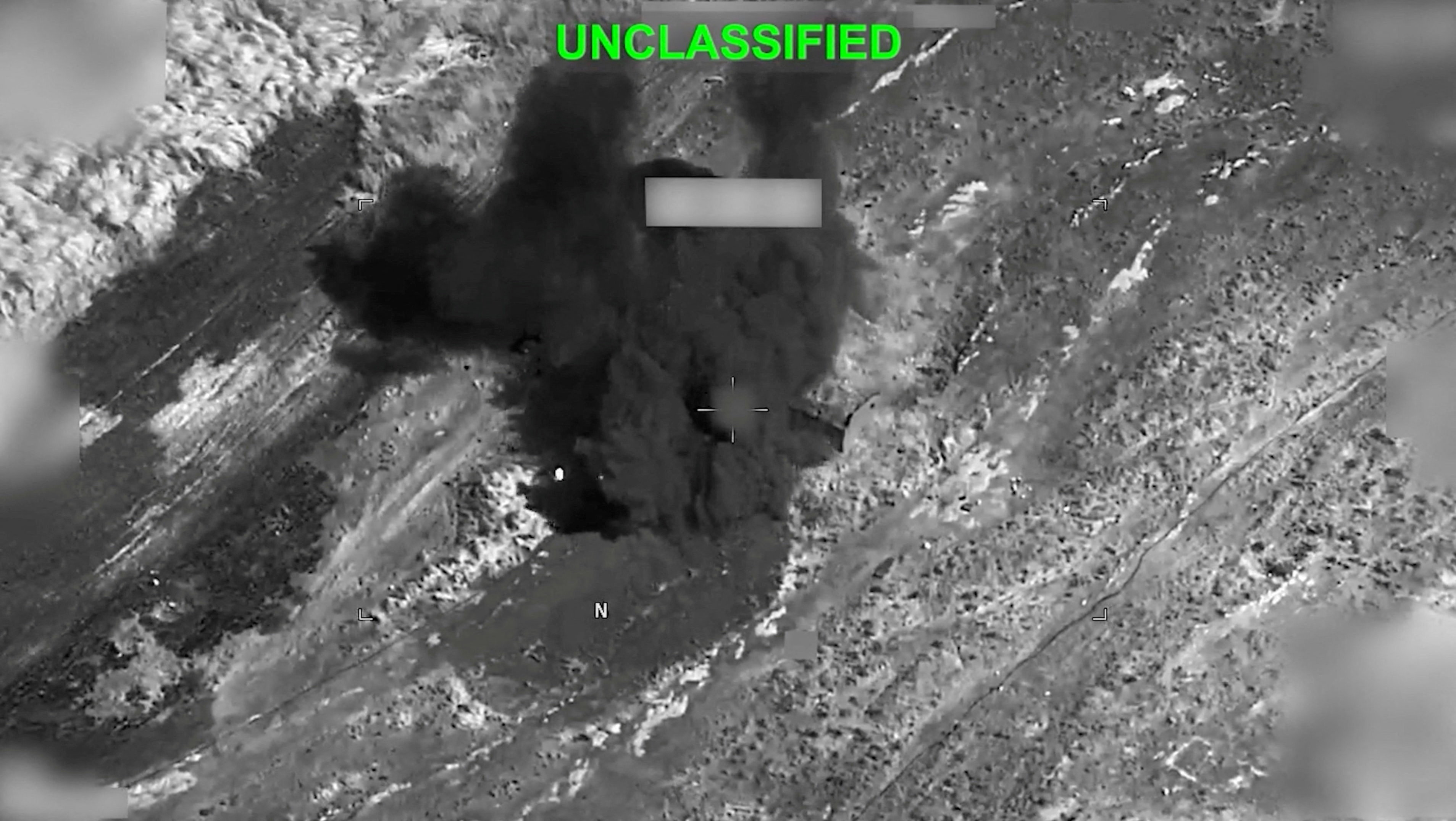 Smoke rises from an explosion at an unknown location, during what US Central Command (CENTCOM) says are strikes on Iran, in this still image taken from a handout video