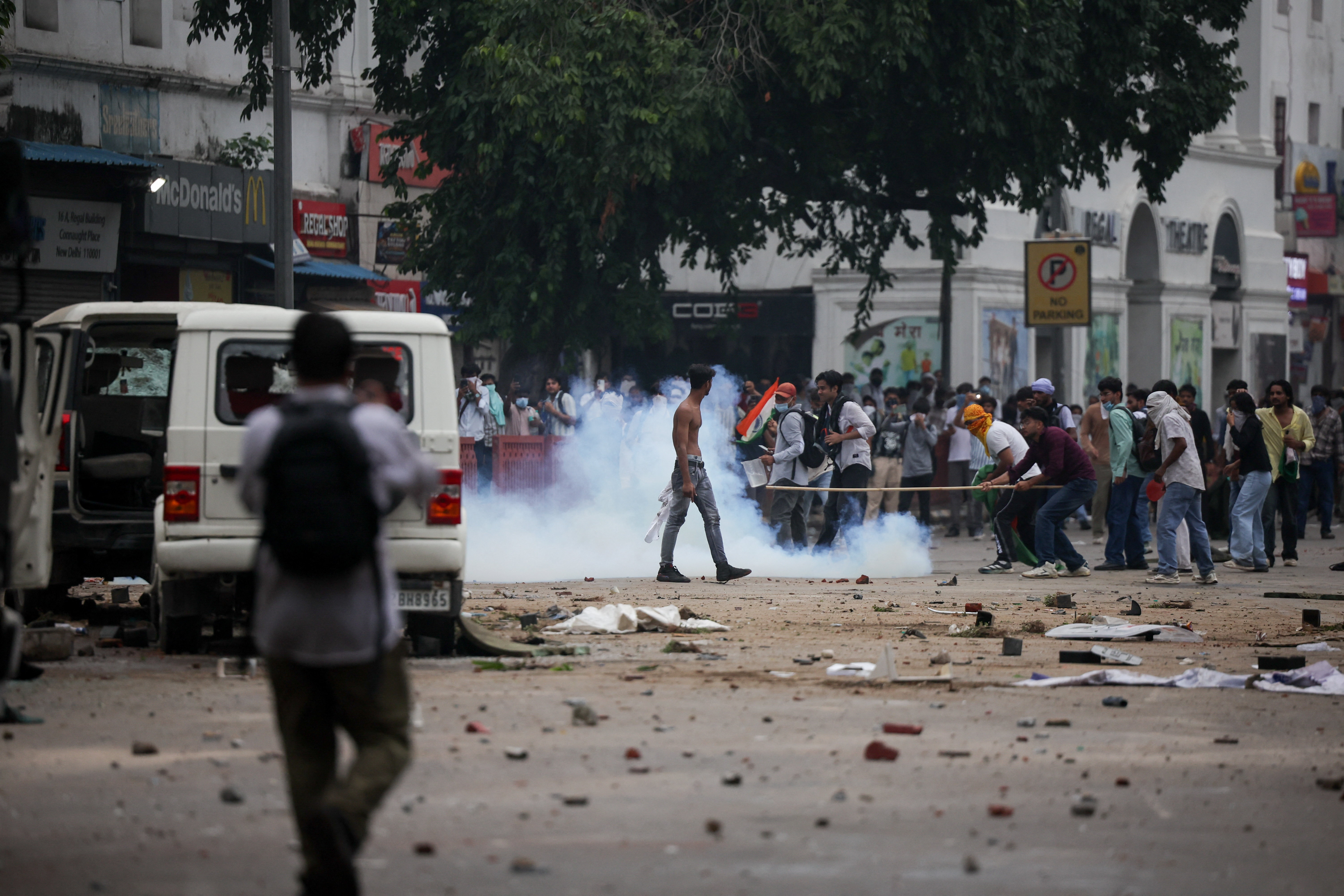 Tear gas spreads around protesters in New Delhi on July 20, 2026