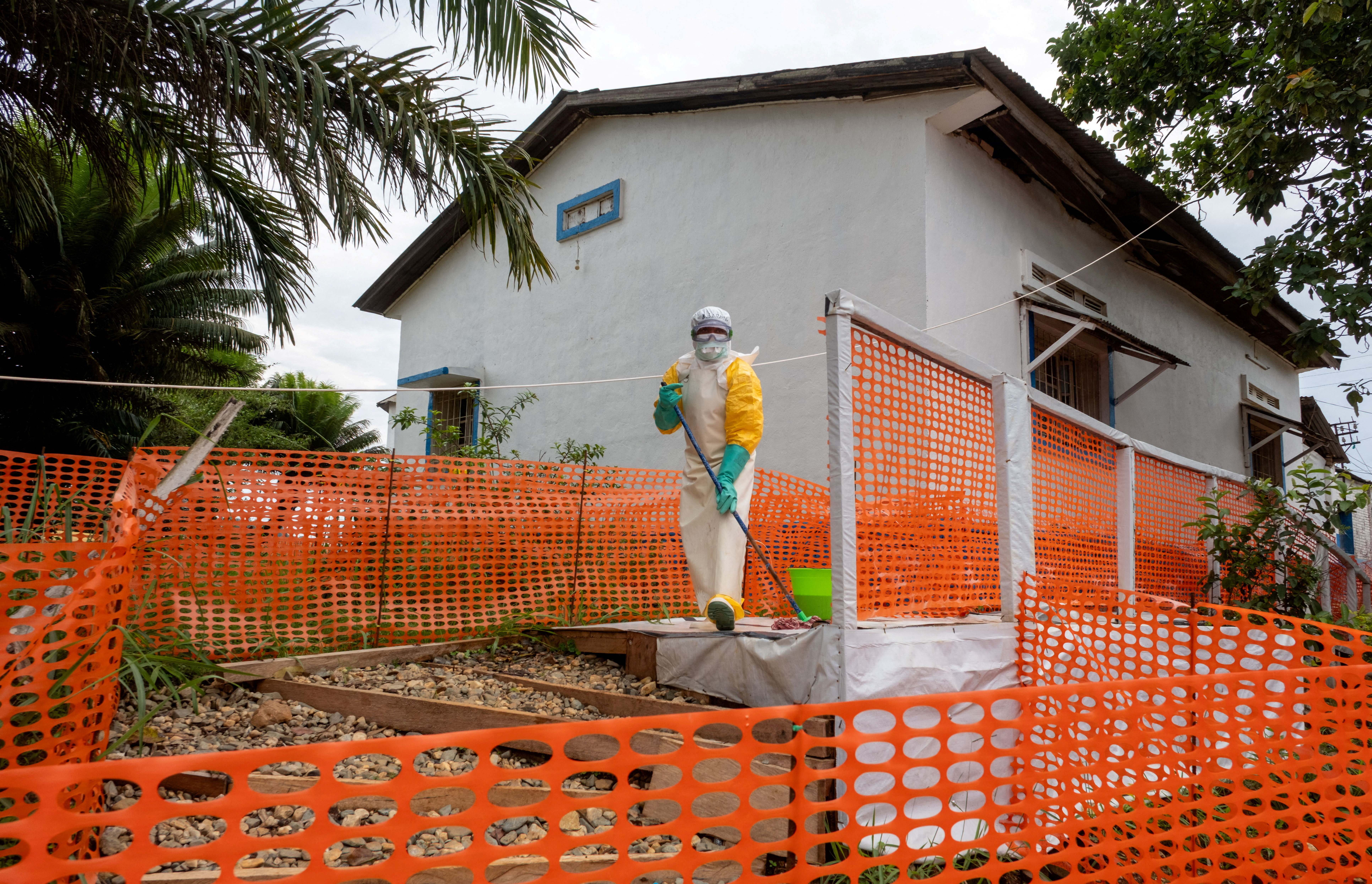 A Congolese health worker cleans outside her station during the tour by Democratic Republic of Congo Prime Minister Judith Suminwa Tuluka, at the Mongbwalu General Hospital in the Ebola-stricken town of Mongbwalu, as authorities intensify efforts to contain the Ebola outbreak involving the Bundibugyo strain on the outskirts of Mongbwalu, Djugu Territory of Ituri province, which is the epicenter of the Ebola epidemic, Democratic Republic of Congo, July 24, 2026. REUTERS/Gradel Muyisa Mumbere TPX IMAGES OF THE DAY