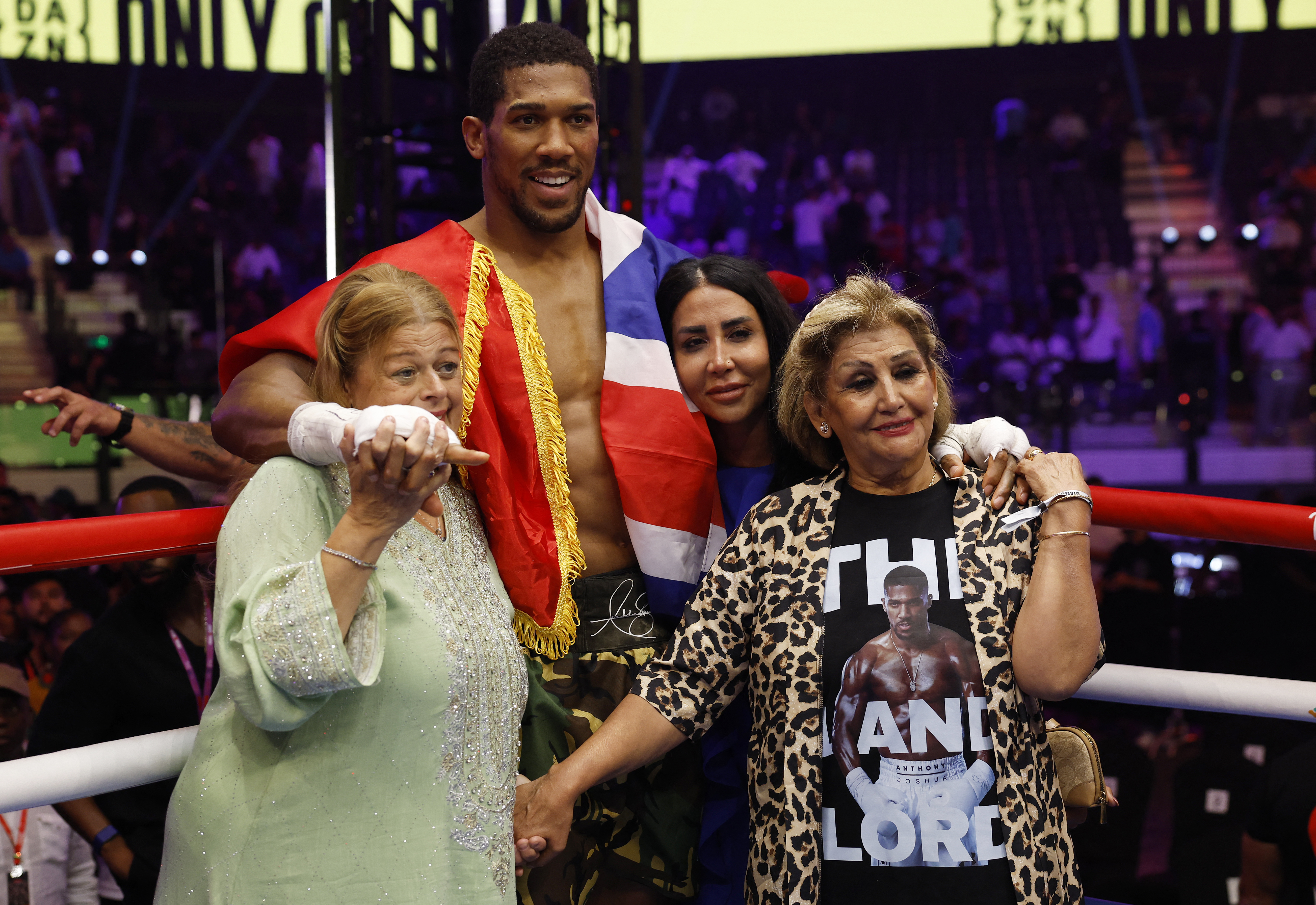 Boxing - The Comeback - Anthony Joshua v Kristian Prenga - Jeddah Superdome, Jeddah, Saudi Arabia - July 26, 2026 Anthony Joshua poses for a picture with his friends' family, Latz and Sina, who died in a tragic car accident, after winning his fight against Kristian Prenga by technical knockout REUTERS/Ibraheem Abu Mustafa