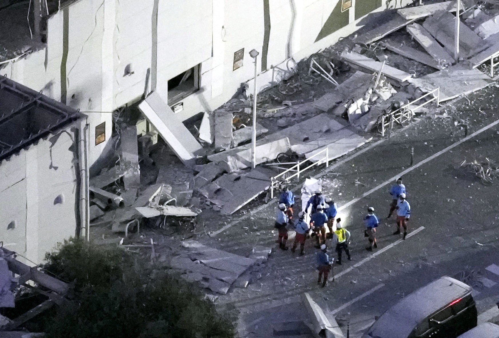 Rescue workers conduct search and rescue operations at the Aeon mall, where an explosion occurred after a magnitude 7.1 earthquake, in Kashima, Kumamoto Prefecture, Japan, July 28, 2026