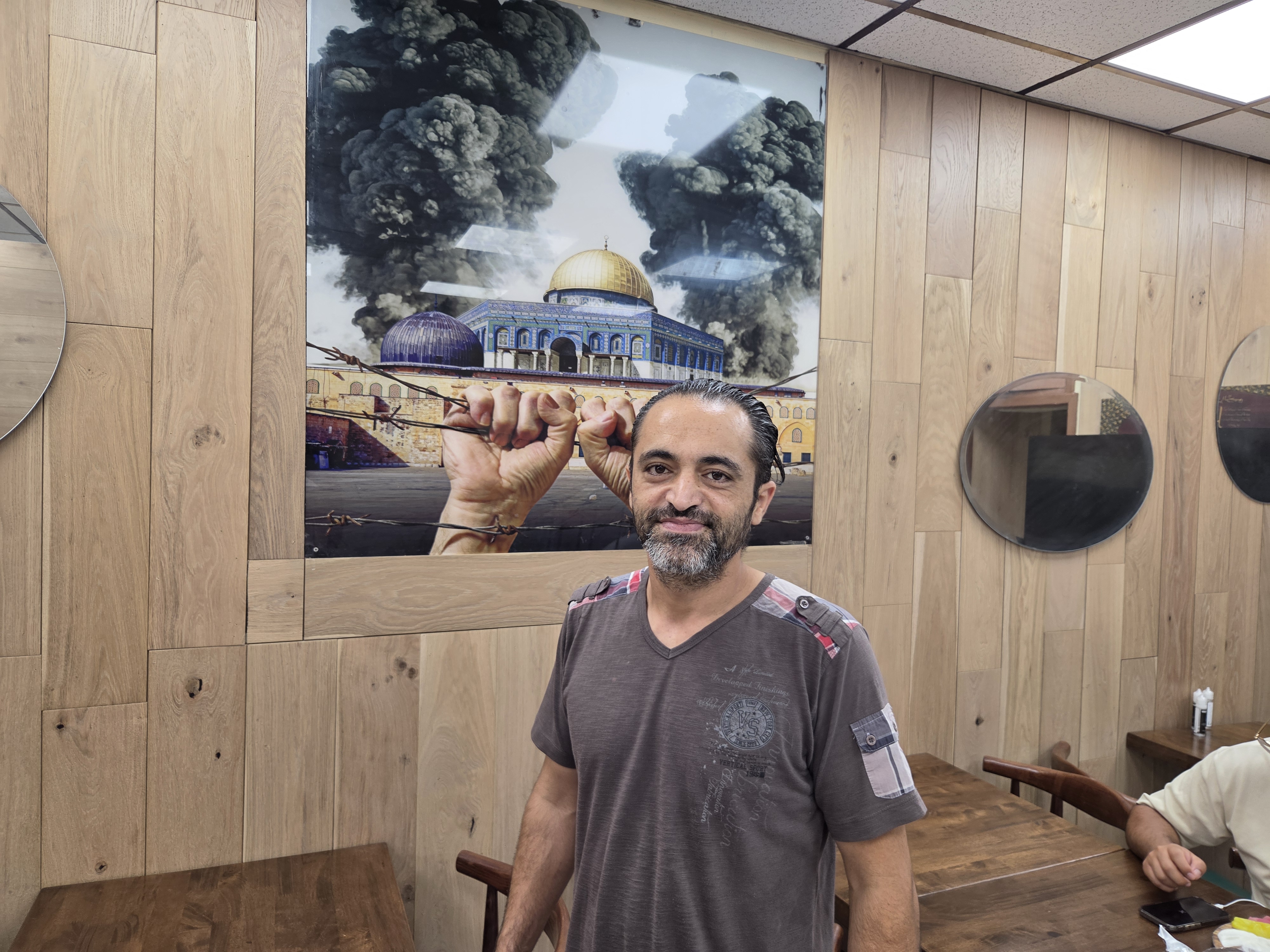 Palestinian American business owner Mahmoud Kasem at his restaurant in Brooklyn, New York, July 17