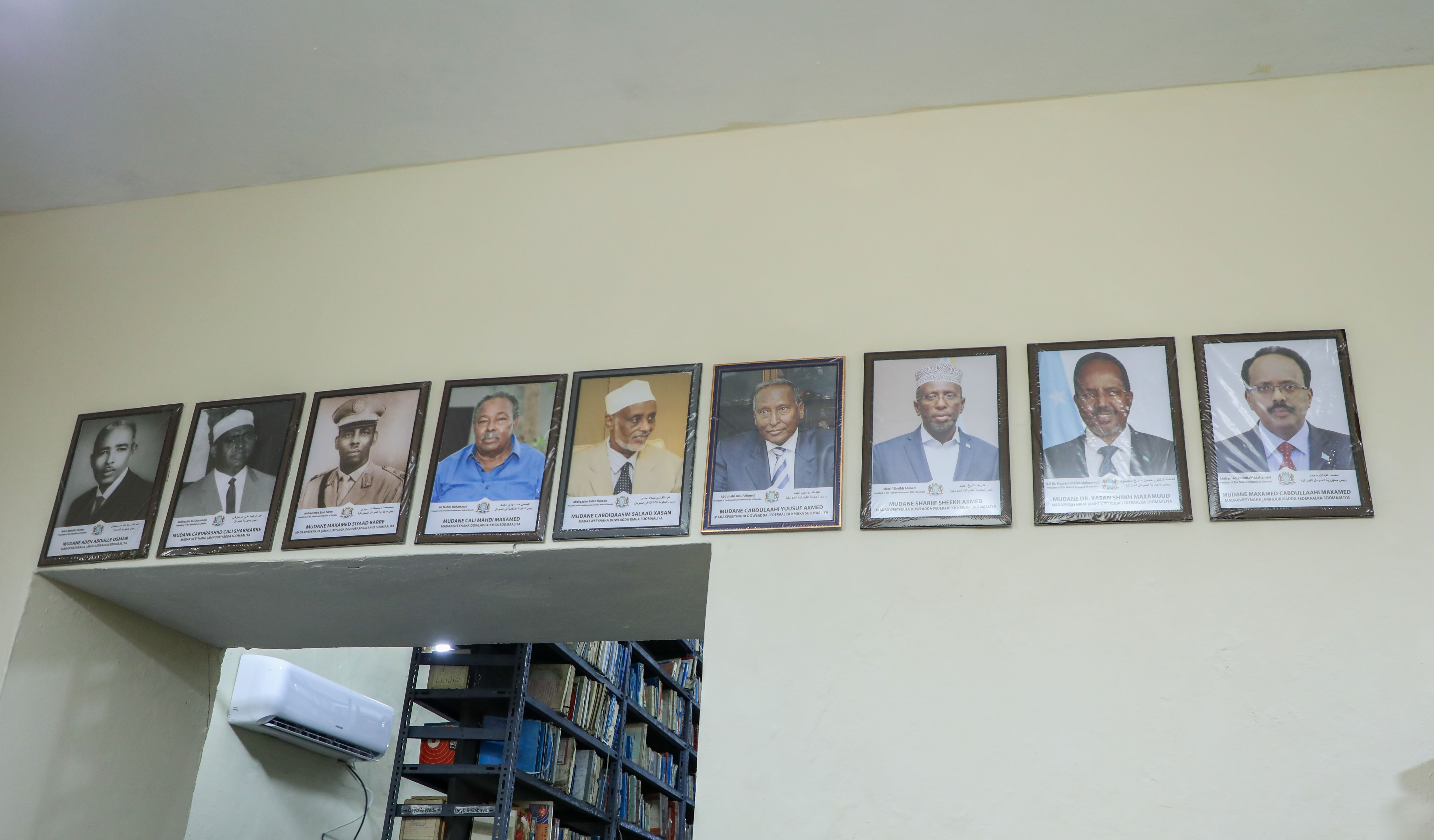 Portraits of Somalia's presidents line a wall at Radio Mogadishu. [Abdimajid Abdillahi Farah/Al Jazeera]