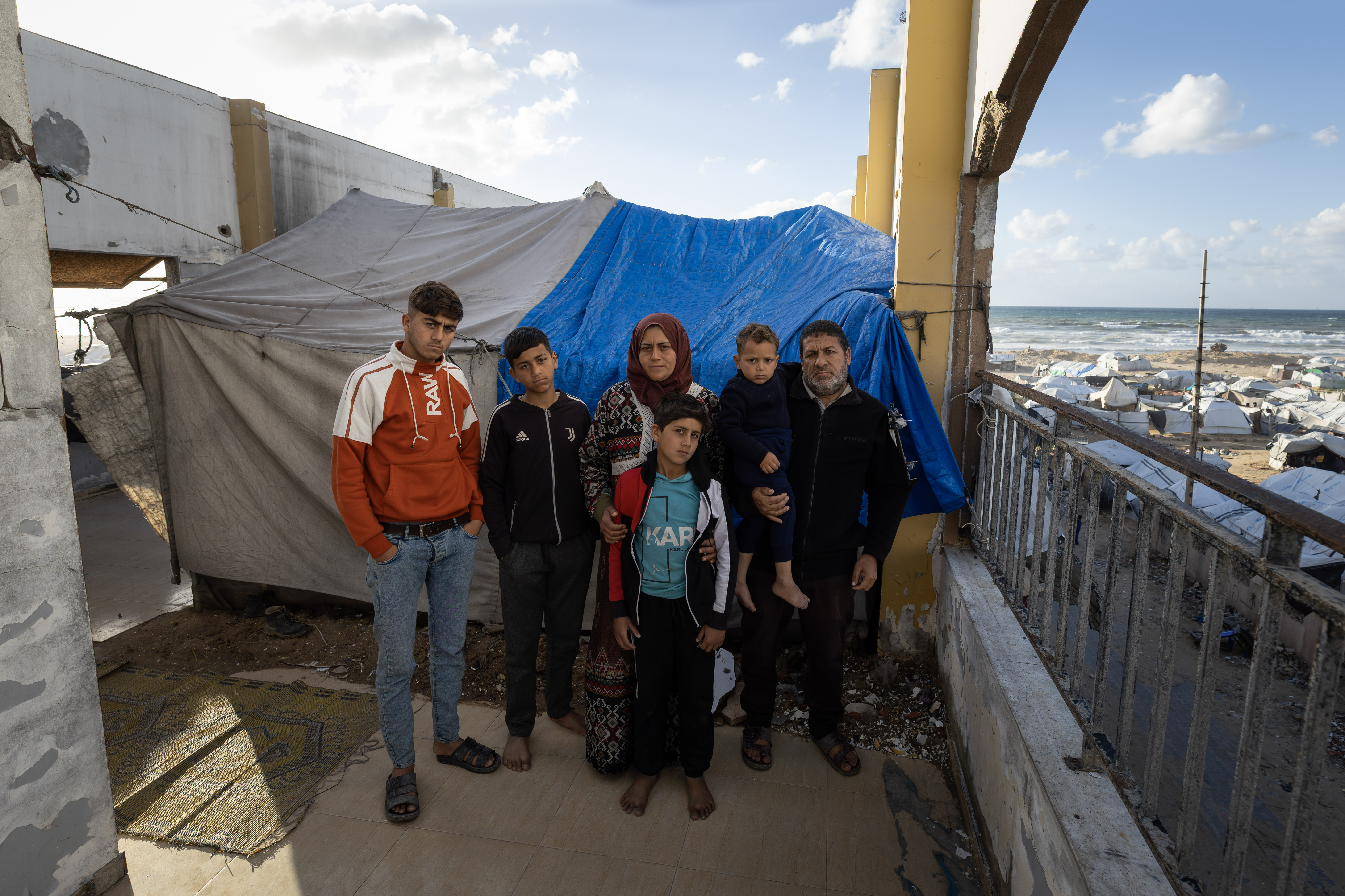 “I can't comprehend everything that's happening to us,” says Rami Azmeila. “Losing my sons, the constant displacement, my injuries… all of this is beyond what any human being can bear.” A father of seven from the Jabalia refugee camp in northern Gaza, Rami lost two of his young sons, aged 24 and 22, when a missile struck his home. Today, his family shelters in a makeshift tent built on the roof of a damaged building near Gaza City.