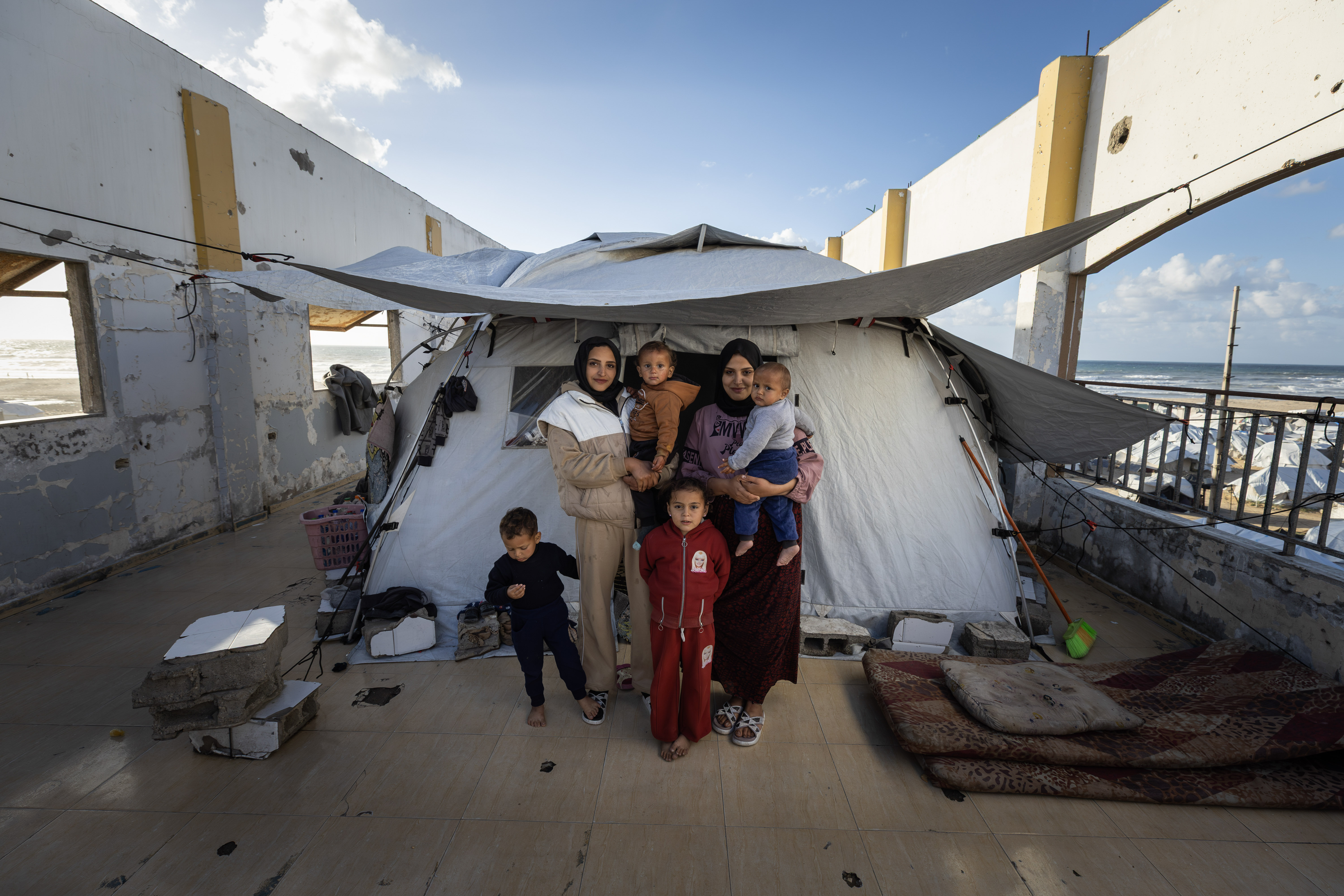 "We try to remain strong for our children, even though the pain is unbearable. We have no choice but to persevere,” says Dina Salem. Dina and Donia Salem are two sisters from Egypt who settled in Gaza after getting married. When the war broke out, they both lost their husbands when their home was bombed and destroyed. After being displaced more than 20 times, they now found a small refuge near the coast in southern Gaza.