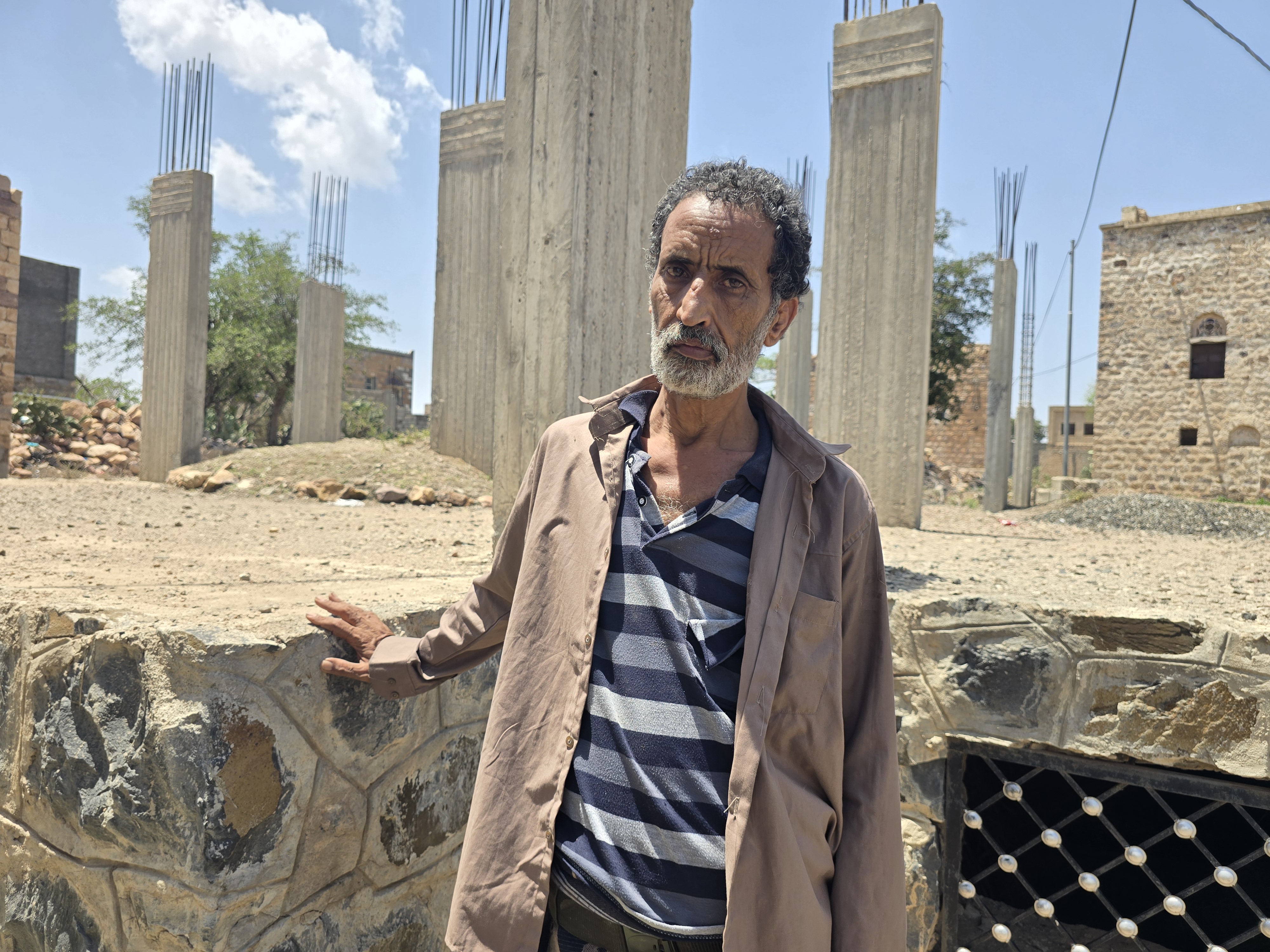 Ahmed Nagi, who is in his 50s, can barely walk without a cane and cannot access the medical care he needs [Nasser al-Sakkaf/Al Jazeera]