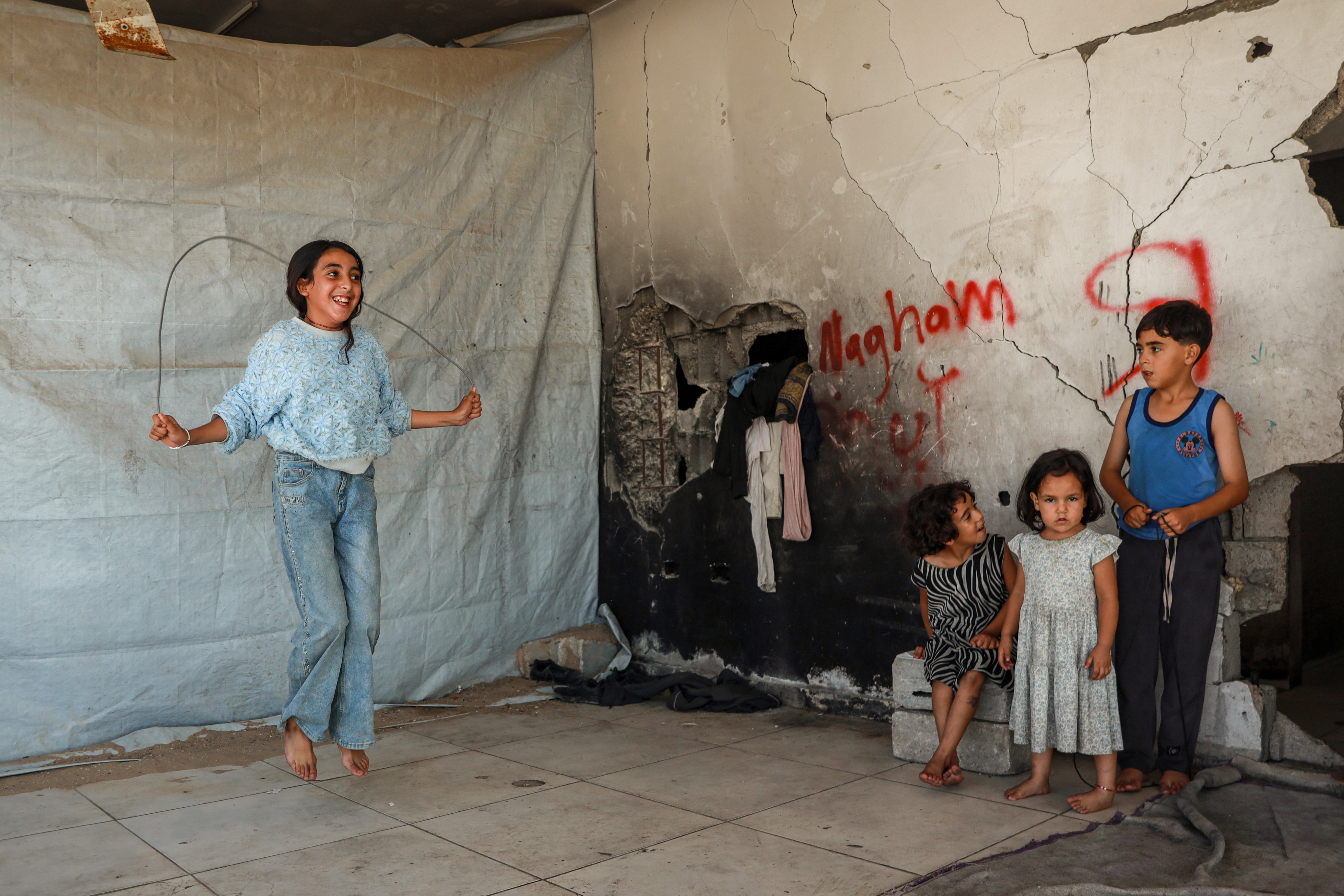 Salsabeel Nabhan skips rope beside her siblings