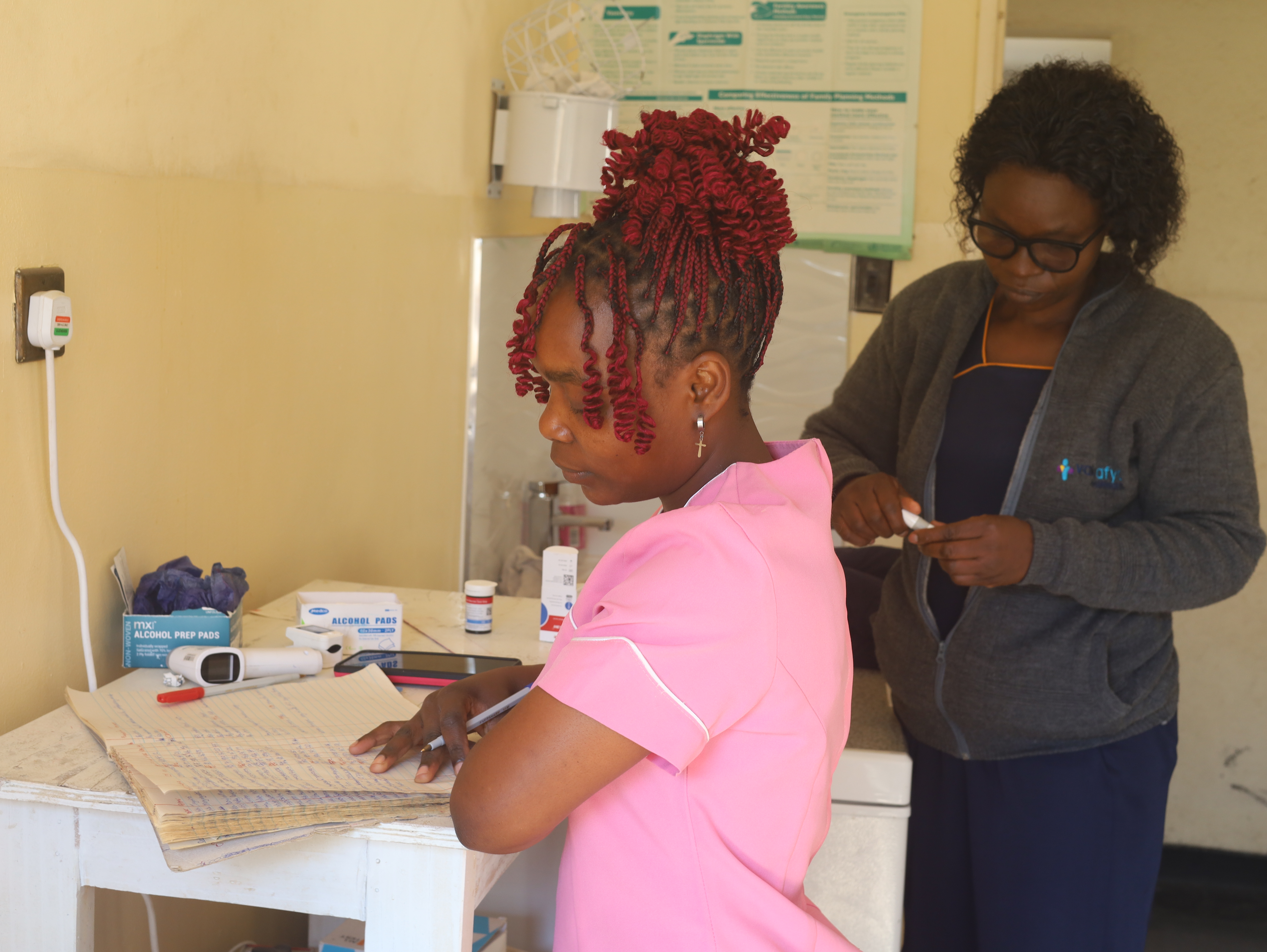 A healthworker assisting patients in a telehealth centre in Nyazura, Zimbabwe (Farai Shawn Matiashe:Al Jazeera)-1784812410