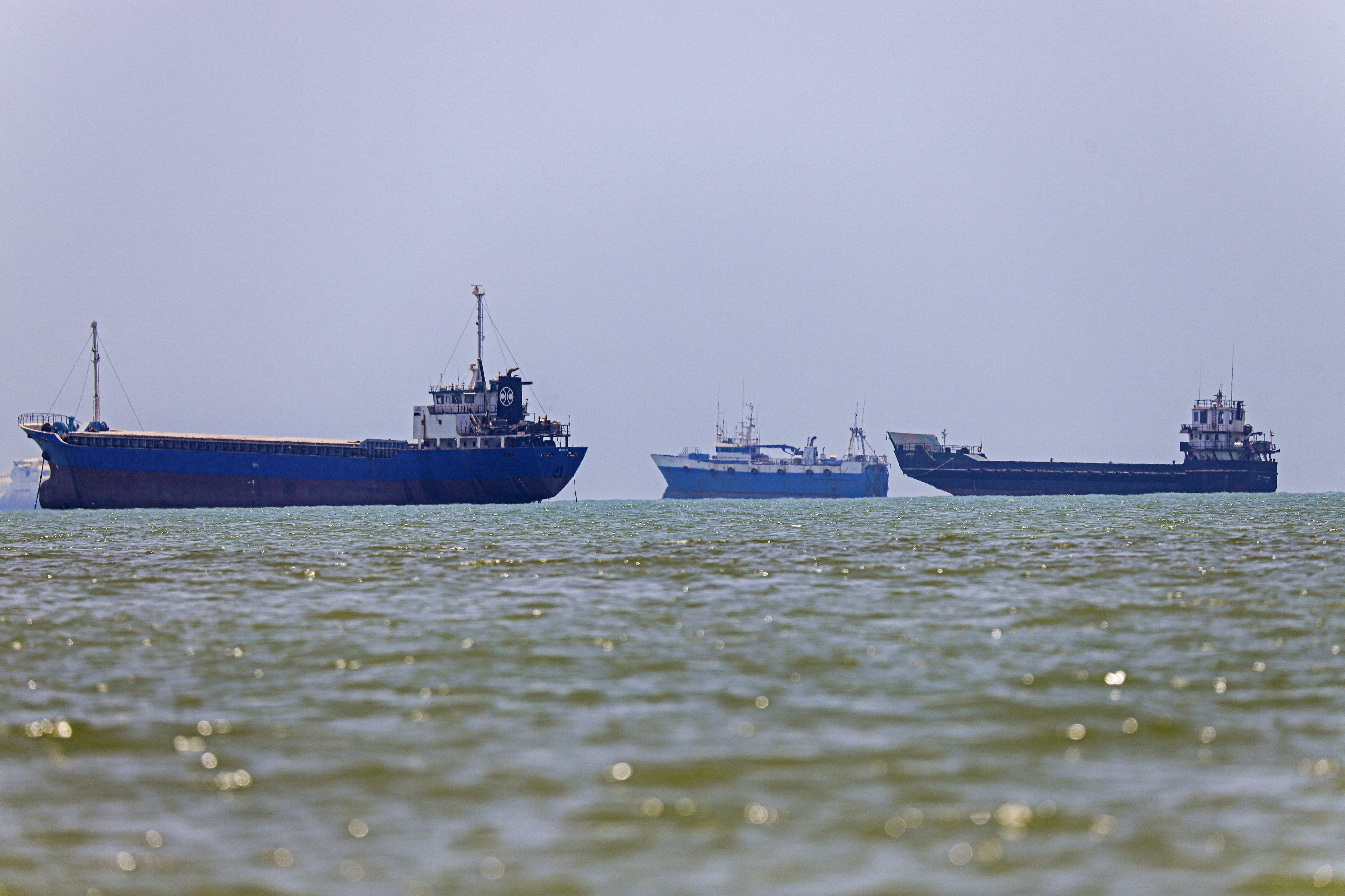 In this picture obtained from Iran's ISNA news agency on June 18, 2026, vessels are seen anchored in Bandar Abbas along the Strait of Hormuz. Oil prices tumbled after Trump and his Iranian counterpart separately signed their accord to end the Middle East war, with the Strait of Hormuz to reopen but two months of negotiations lying ahead. (Photo by AMIRHOSSEIN KHORGOOEI / ISNA / AFP) /