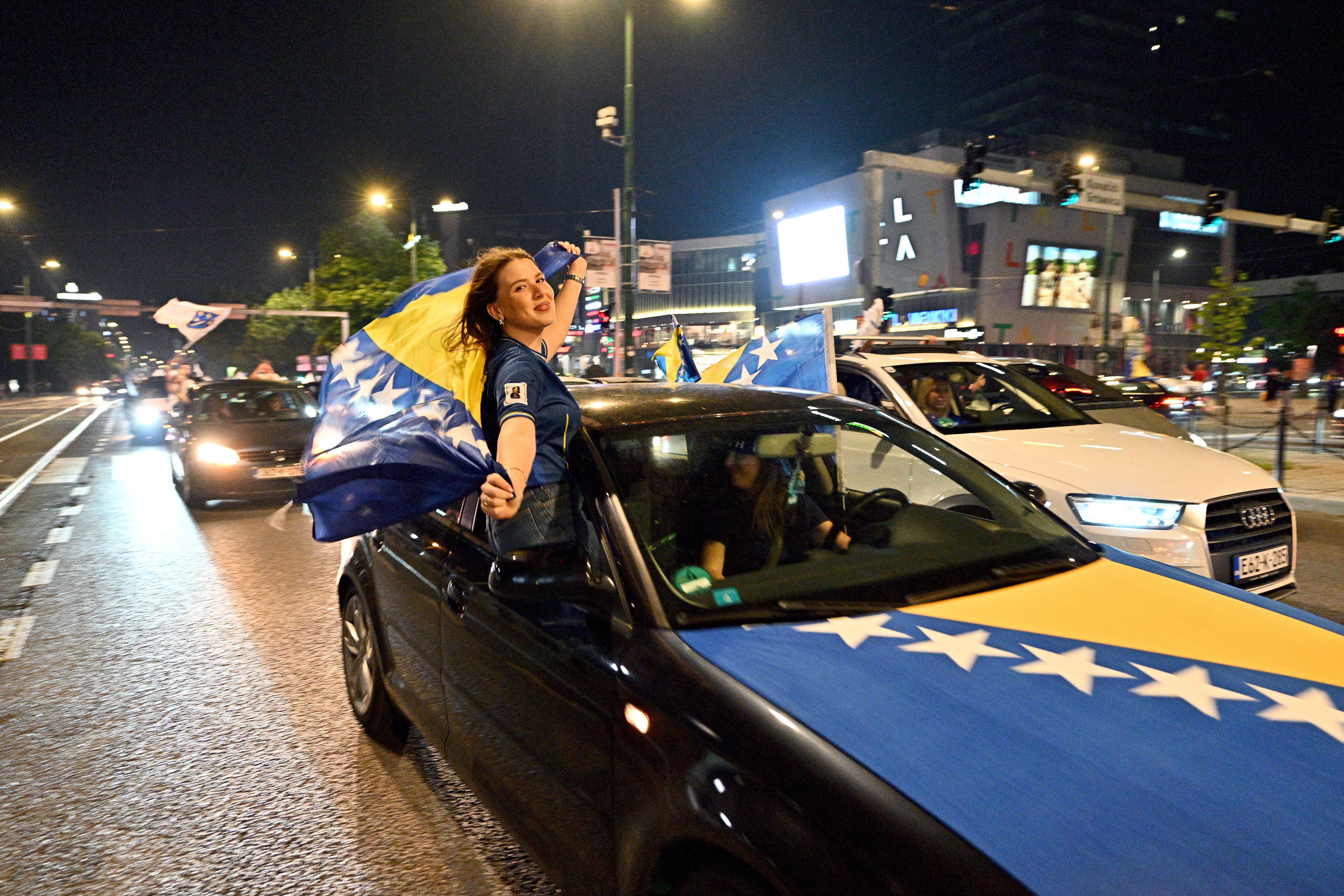 Bosnia and Herzegovina's supporters celebrate in the streets at the end of the Bosnia and Herzegovina World Cup 2026 football match against Qatar in Sarajevo on June 24, 2026. (Photo by ELVIS BARUKCIC / AFP)