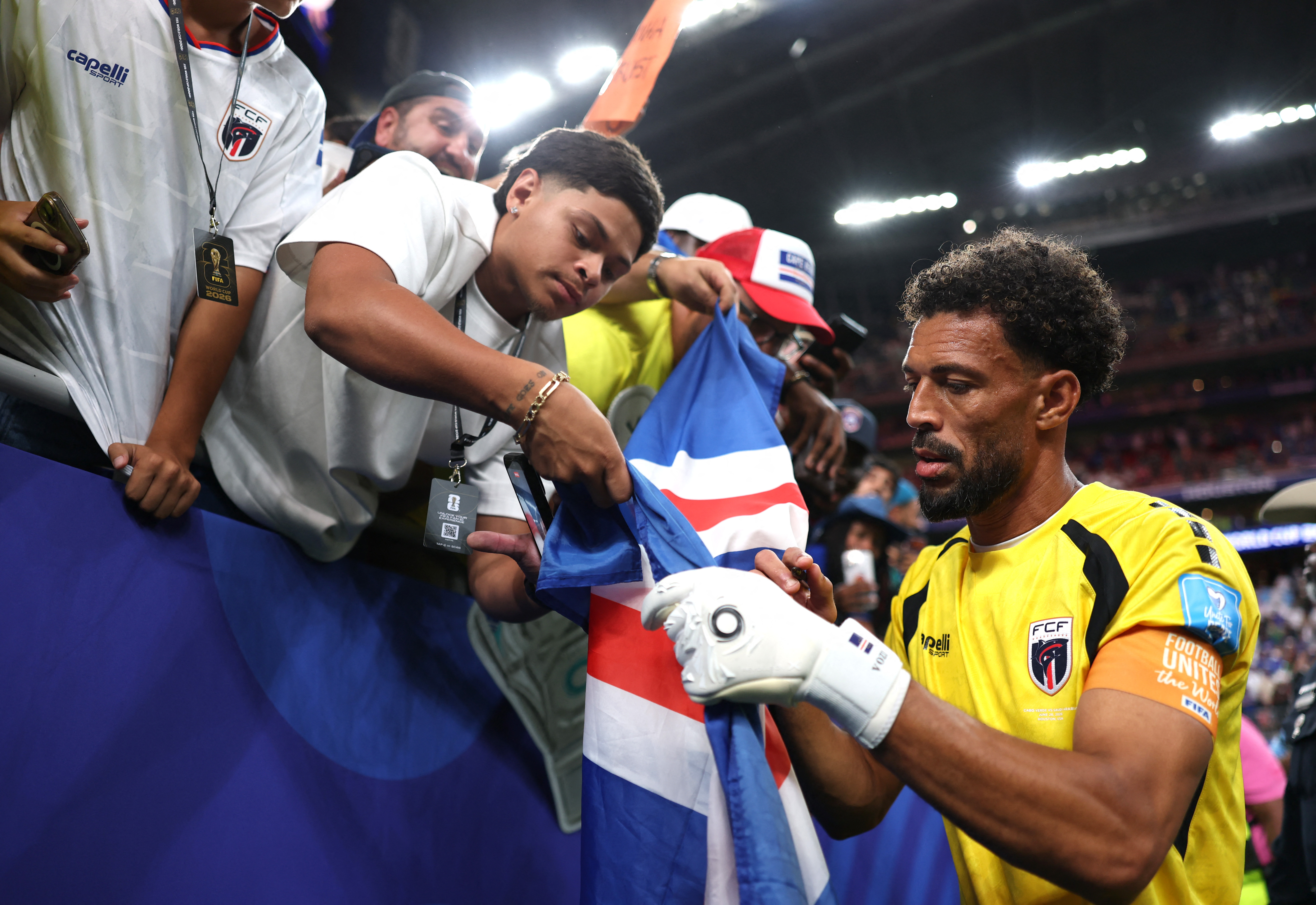 HOUSTON, TEXAS - JUNE 26: Vozinha #1 of Cabo Verde signs autographs for fans after the 0-0 draw during the FIFA World Cup 2026 Group H match between Cabo Verde and Saudi Arabia at Houston Stadium on June 26, 2026 in Houston, Texas. Michael Steele/Getty Images/AFP (Photo by MICHAEL STEELE / GETTY IMAGES NORTH AMERICA / Getty Images via AFP)