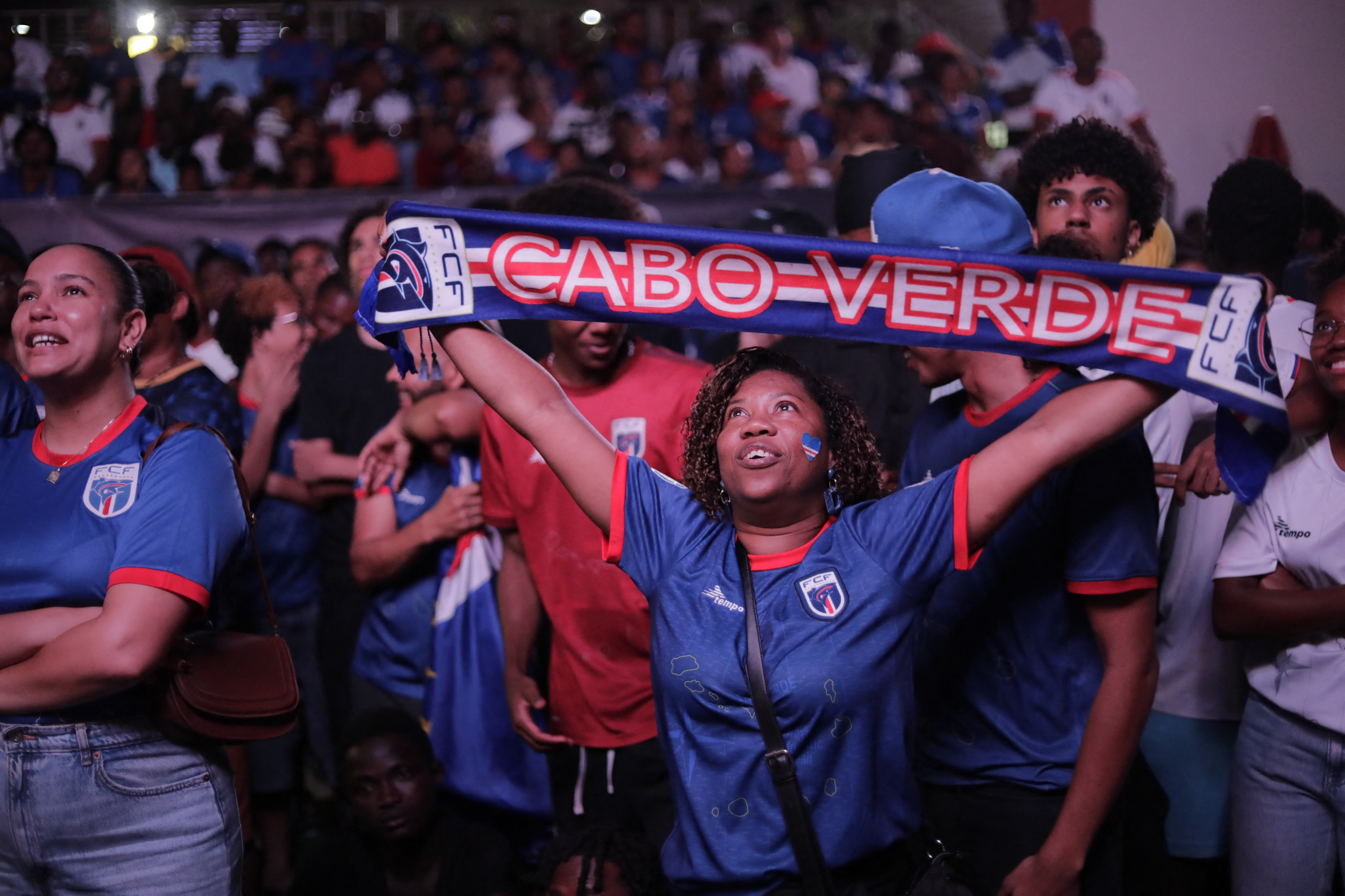A supporter of Cape Verde's national football team reacts as she watches the 2026 World Cup football tournament match between Cape Verde and Saudi Arabia in Praia, on June 26, 2026. (Photo by Jose Correia / AFP)