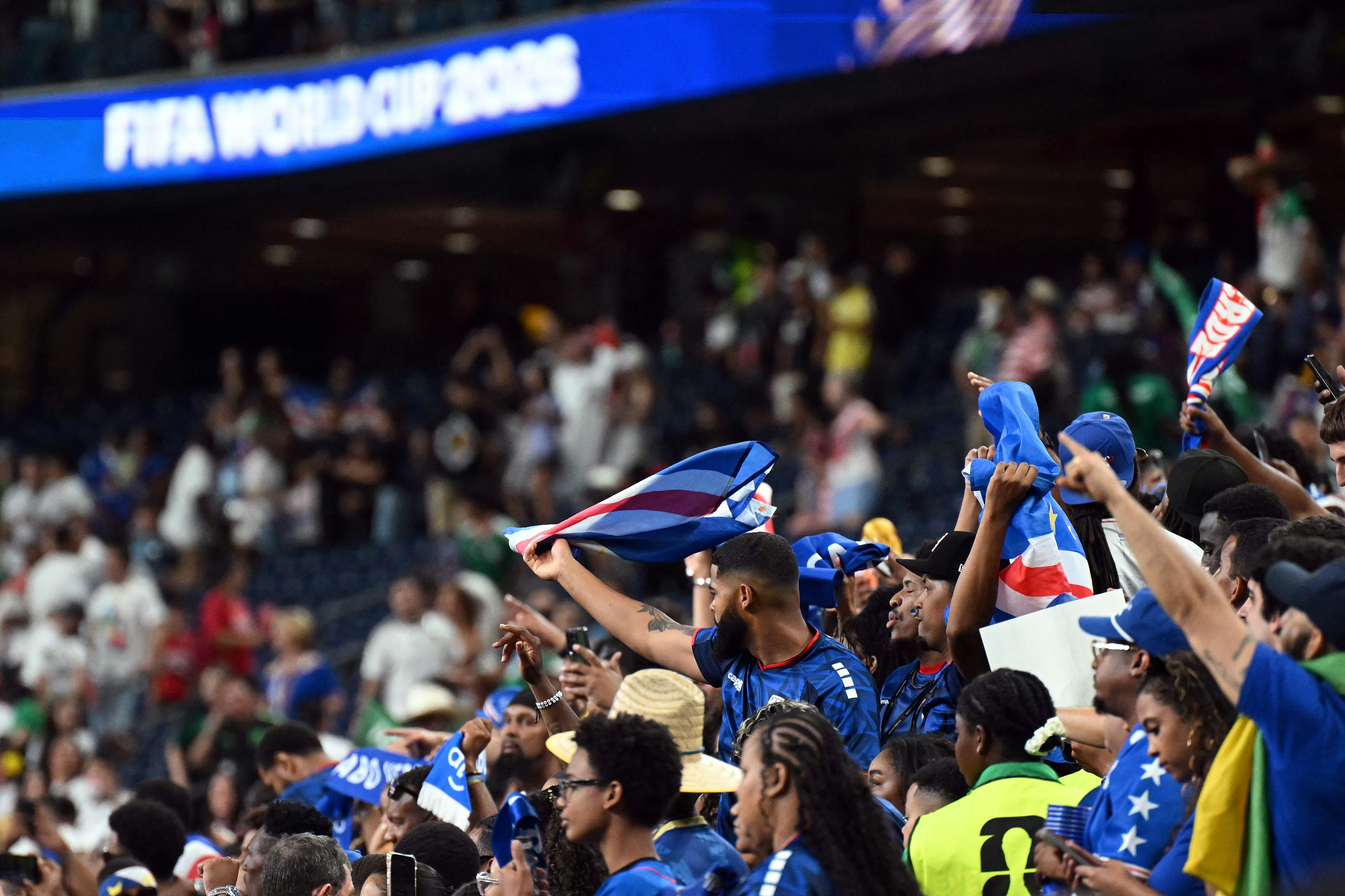 Cape Verde supporters celebrate after the 2026 World Cup Group H football match between Cape Verde and Saudi Arabia at the Houston Stadium in Houston on June 26, 2026. The game finished 0-0. (Photo by RONALDO SCHEMIDT / AFP)
