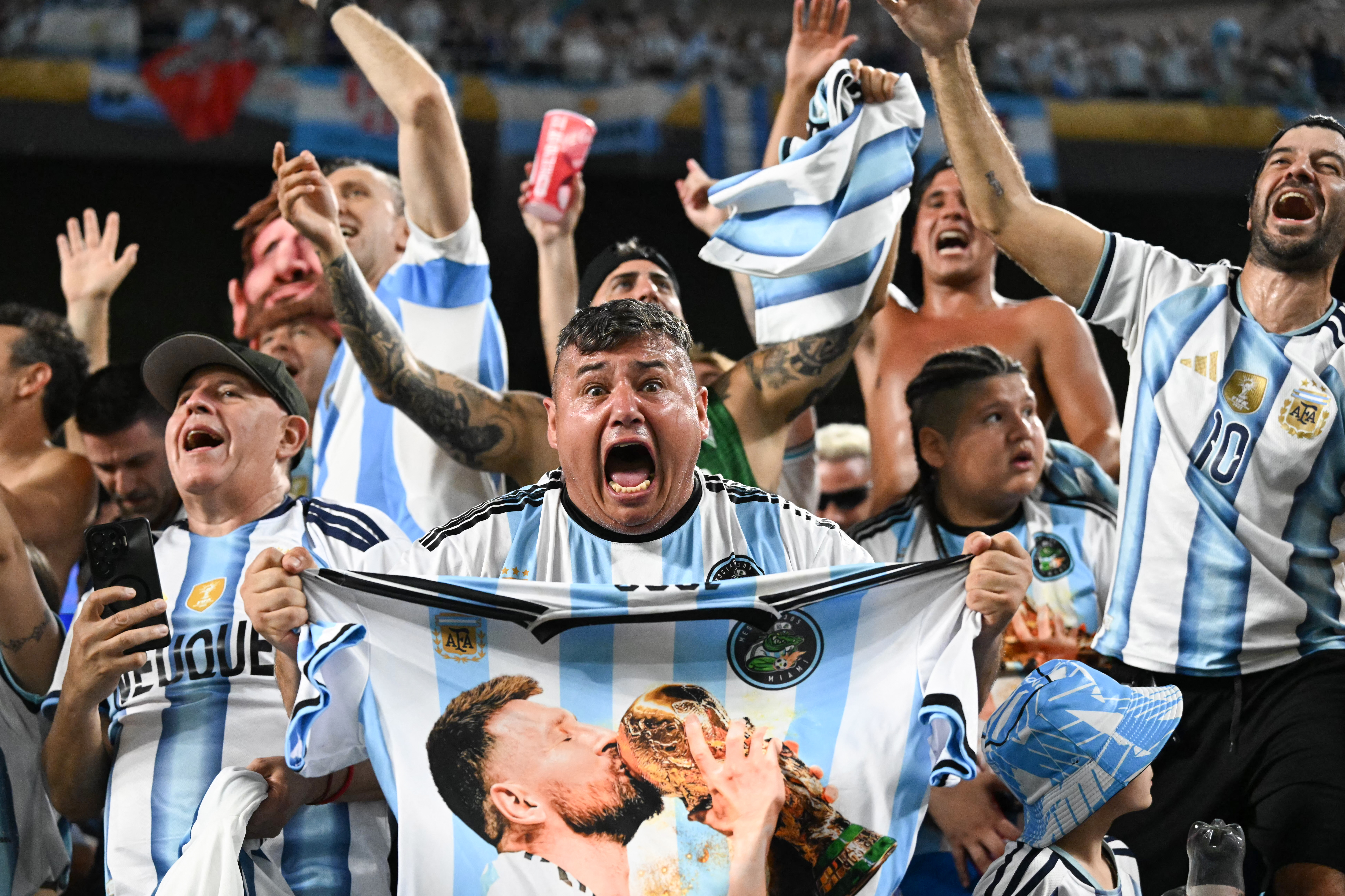 Argentine fans celebrate at the end of the 2026 World Cup round of 32 football match between Argentina and Cape Verde at the Miami Stadium in Miami Gardens on July 3, 2026. (Photo by ROBERTO SCHMIDT / AFP)