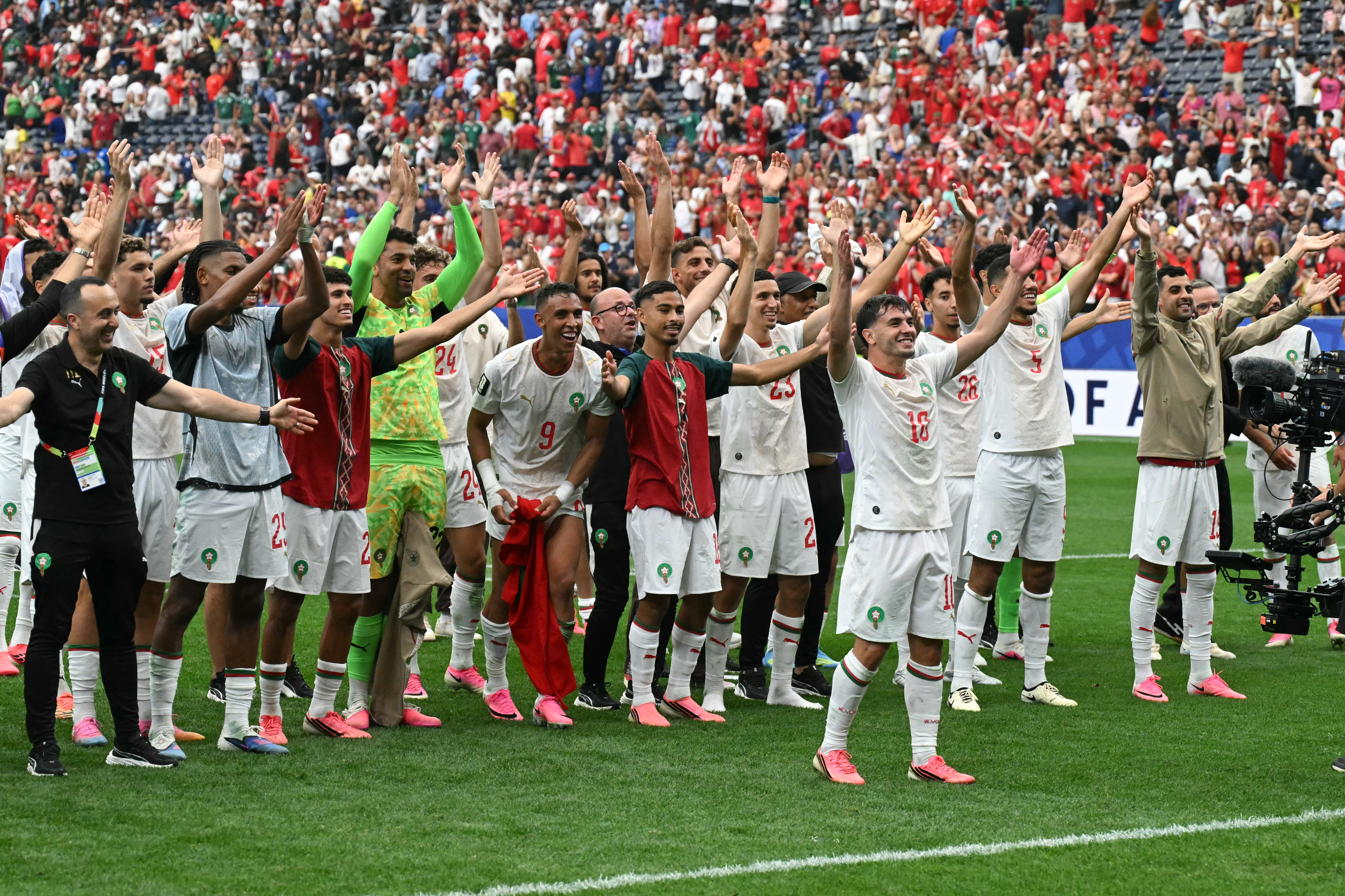 Morocco's forward #10 Brahim Diaz and teammates celebrate after winning the 2026 World Cup round of 16 football match between Canada and Morocco at the Houston Stadium in Houston on July 4, 2026. (Photo by RONALDO SCHEMIDT / AFP)