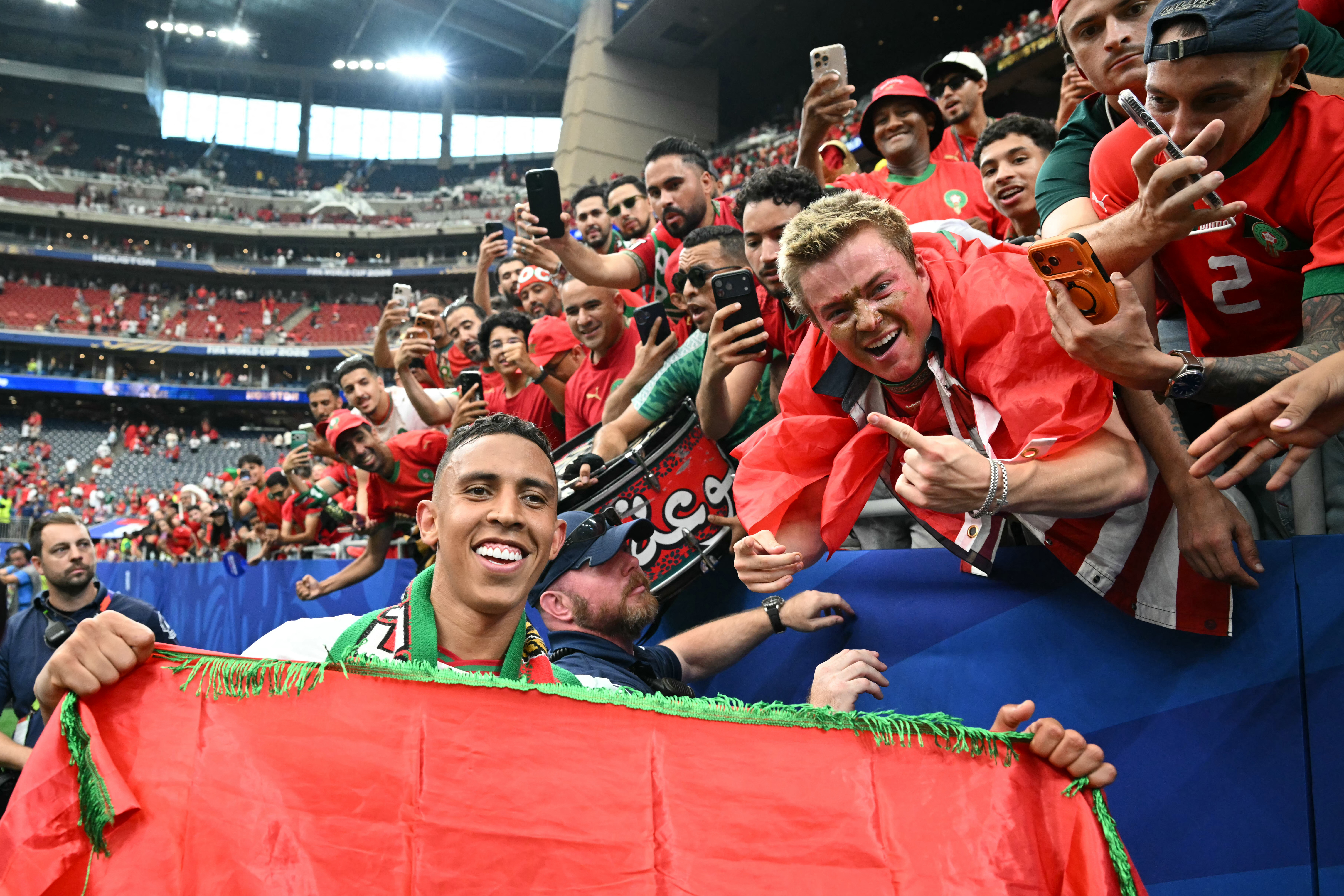 Morocco's forward #09 Soufiane Rahimi poses for a photo with fans as they celebrate winning the 2026 World Cup round of 16 football match between Canada and Morocco at the Houston Stadium in Houston on July 4, 2026. (Photo by RONALDO SCHEMIDT / AFP)