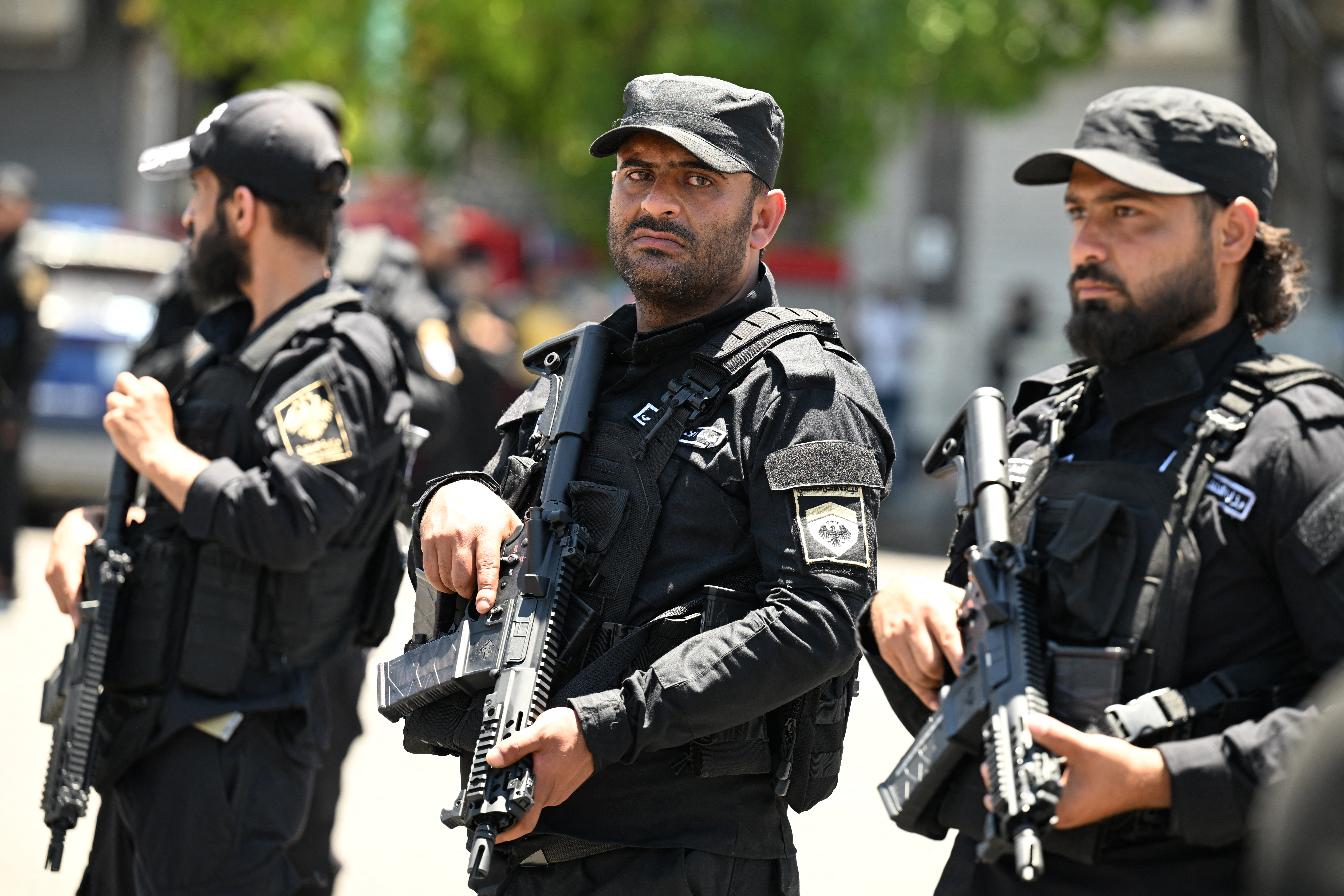 Security personnel stand guard near the Four Seasons Hotel