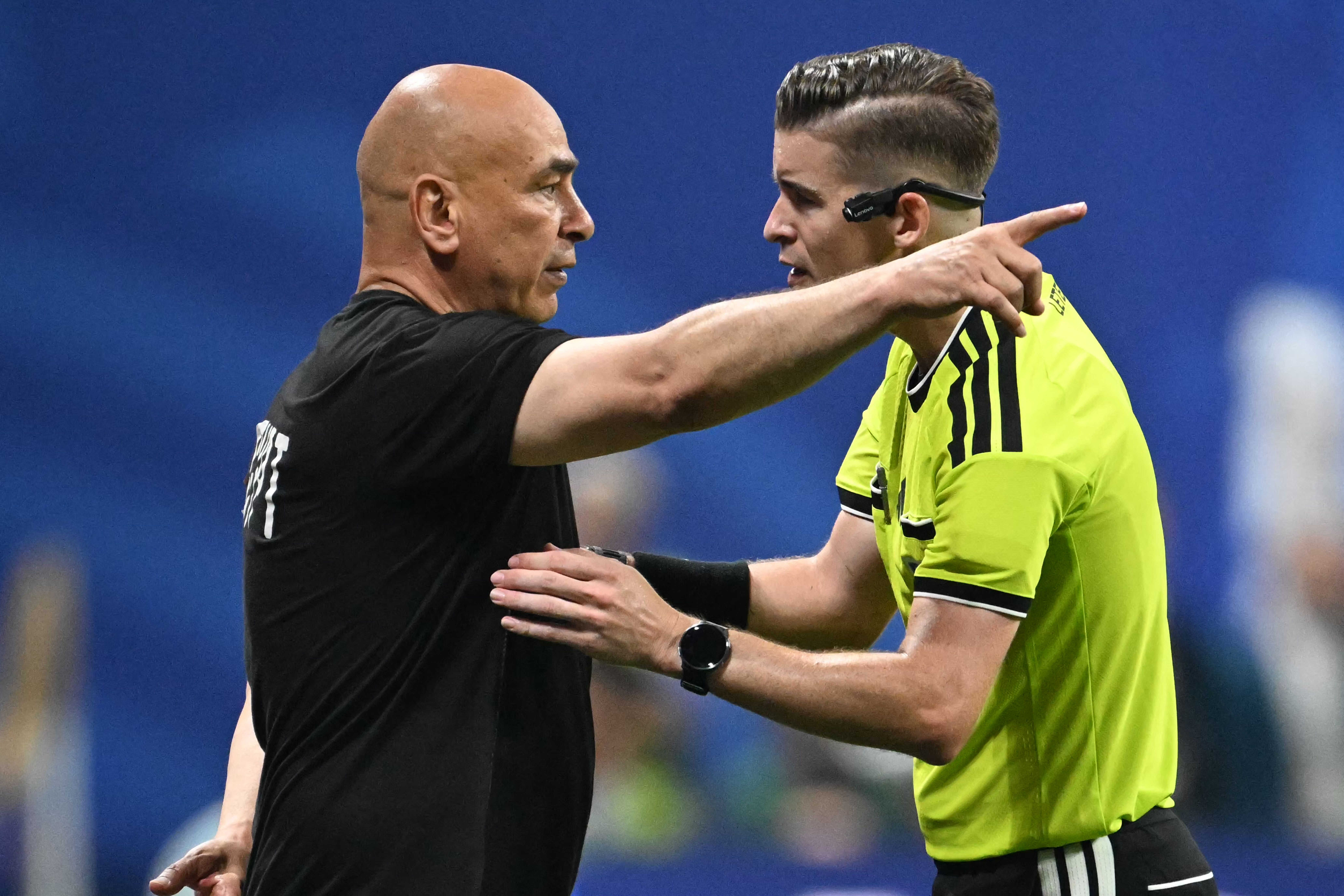 Egypt's head coach Hossam Hassan speaks with French referee Francois Letexier during the 2026 World Cup round of 16 football match between Argentina and Egypt at Atlanta Stadium in Atlanta on July 7, 2026. (Photo by ROBERTO SCHMIDT / AFP)