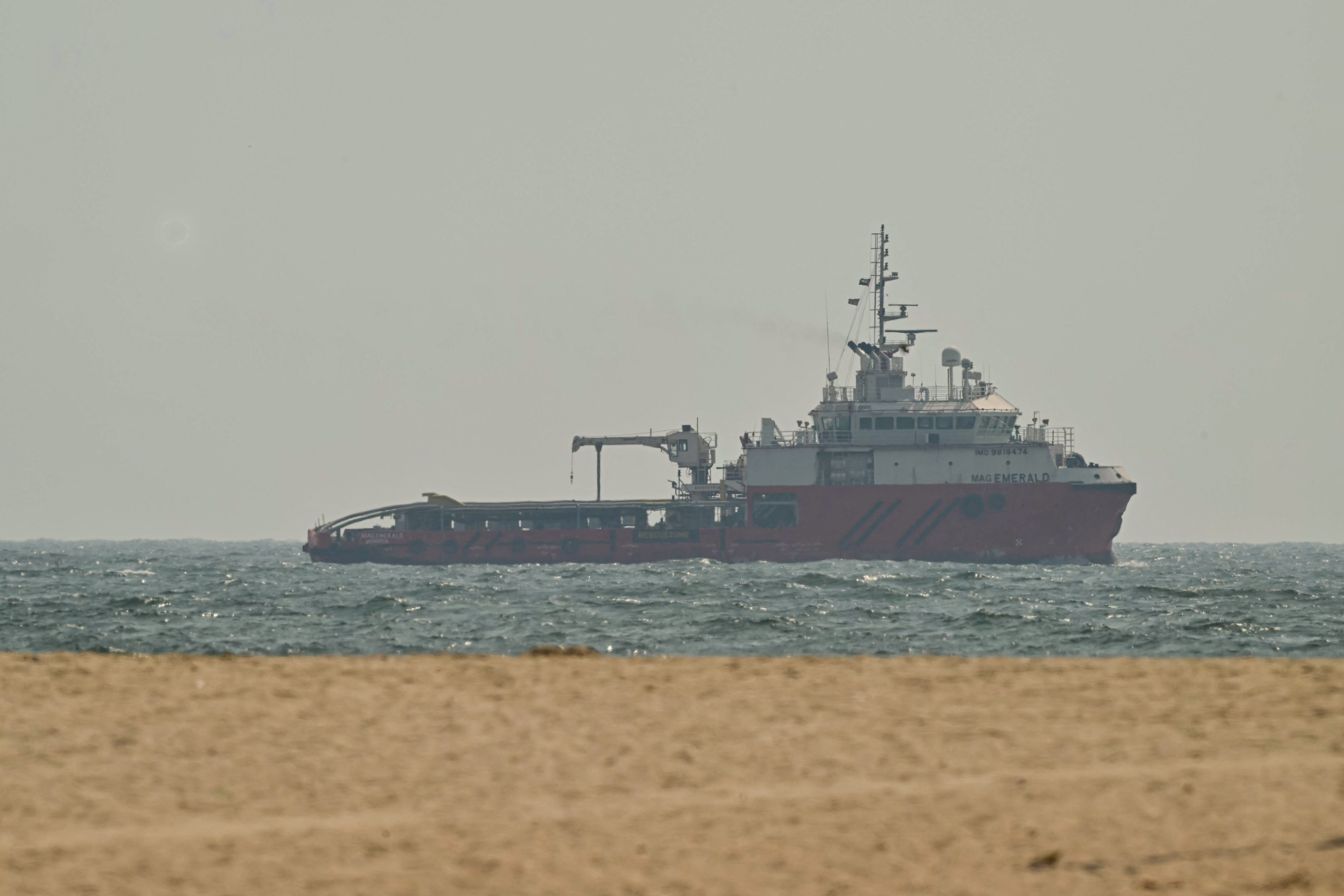 A ship sails off the coast of Ajman on July 10, 2026.